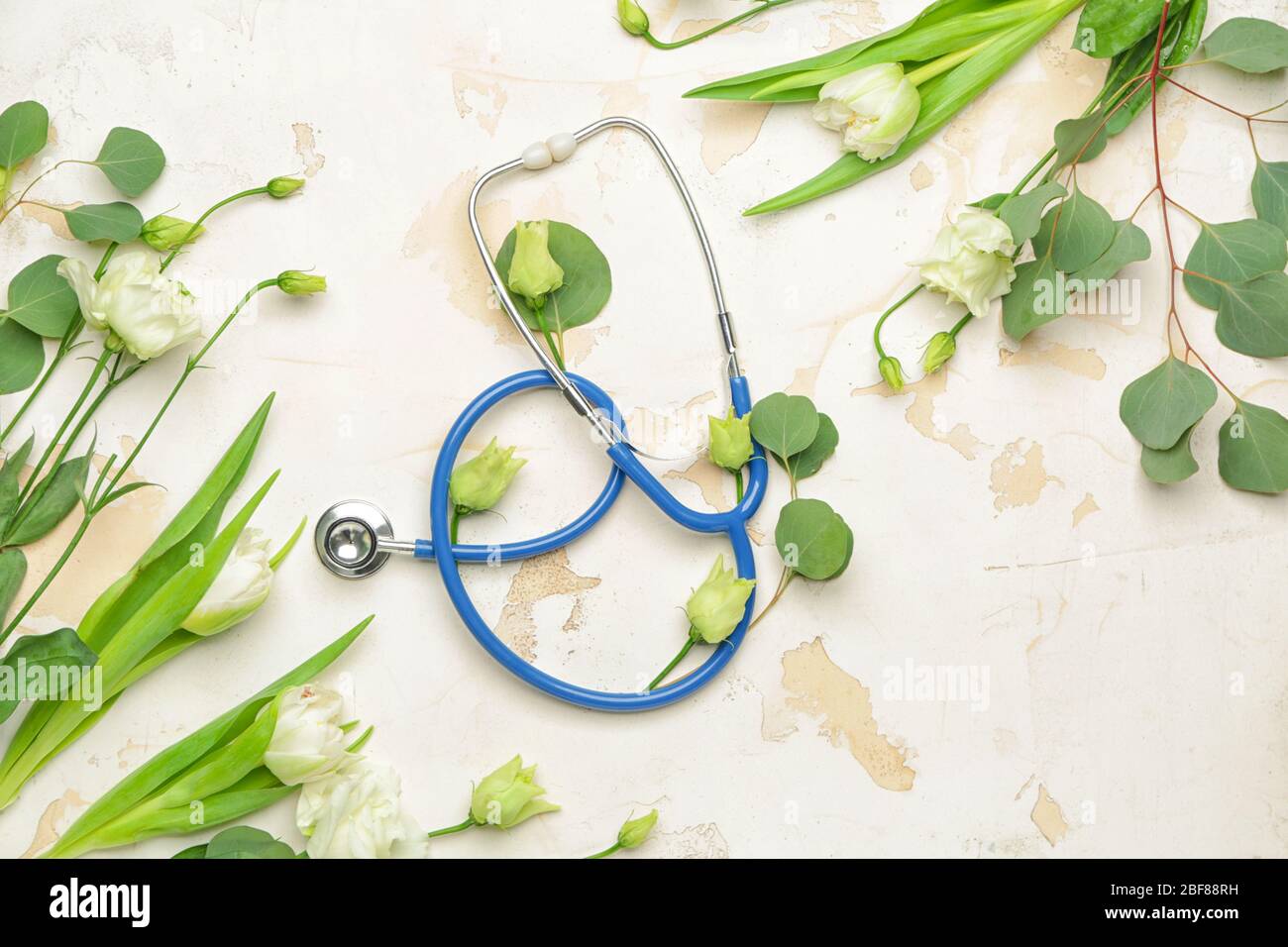 Stethoscope with flowers on white background Stock Photo - Alamy