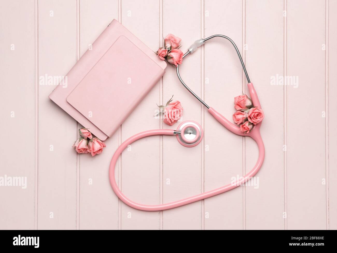 Stethoscope with flowers and notebooks on white wooden background Stock  Photo - Alamy