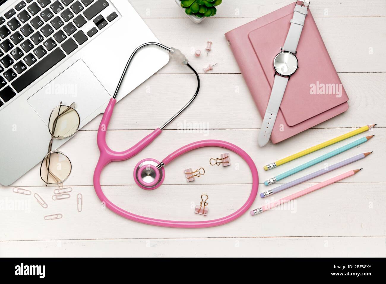 Stethoscope with laptop and stationery on wooden table Stock Photo - Alamy