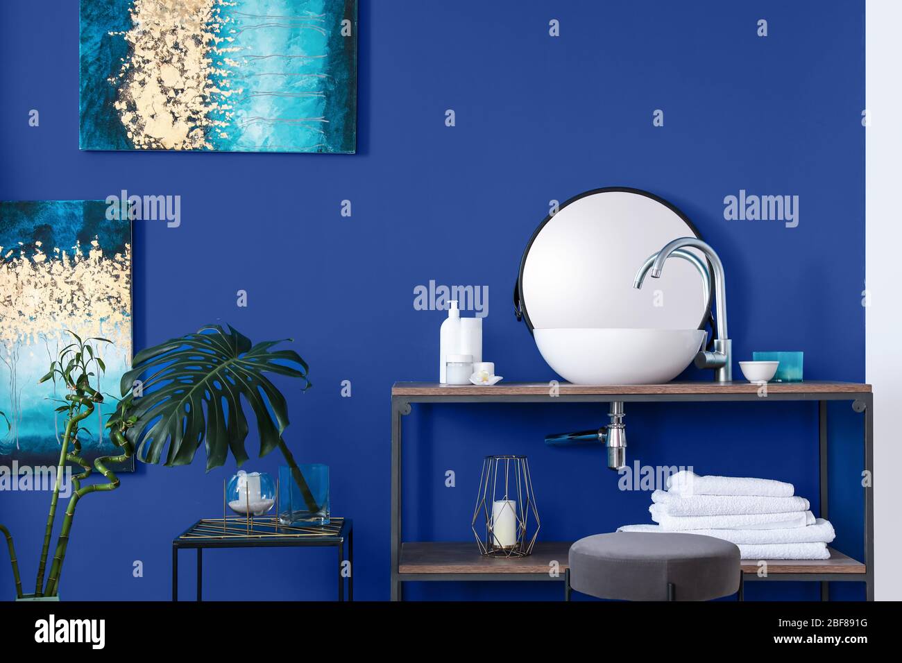 Interior of modern bathroom with blue wall Stock Photo - Alamy