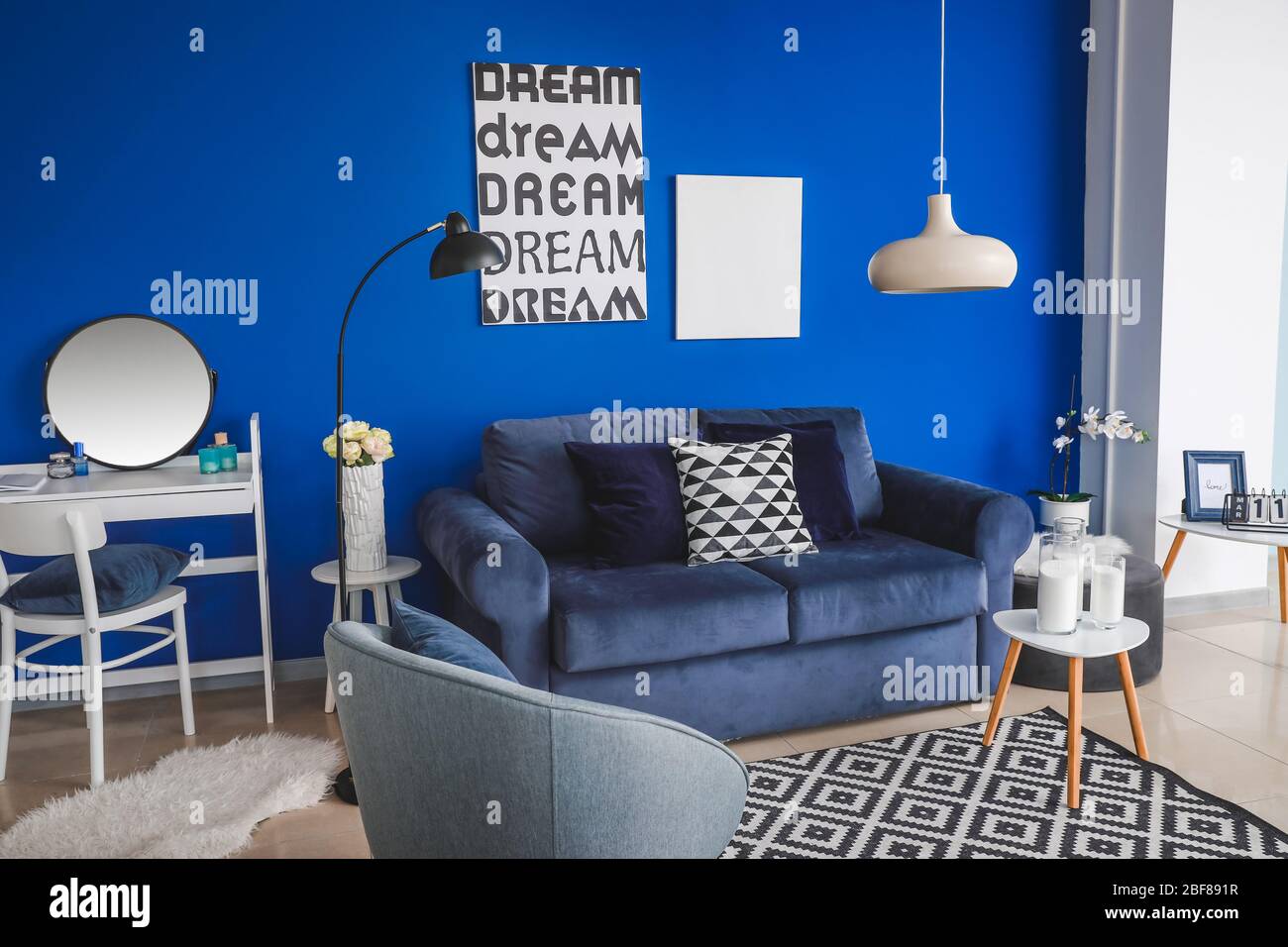 Interior of modern living room with blue wall Stock Photo - Alamy