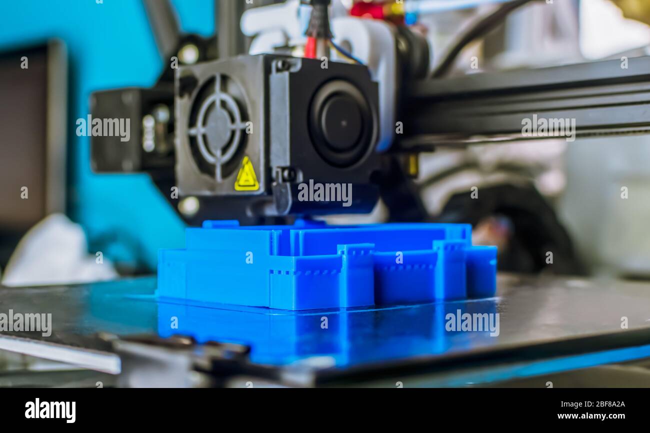 The 3D printer prints blue plastic model. modern technology Stock Photo