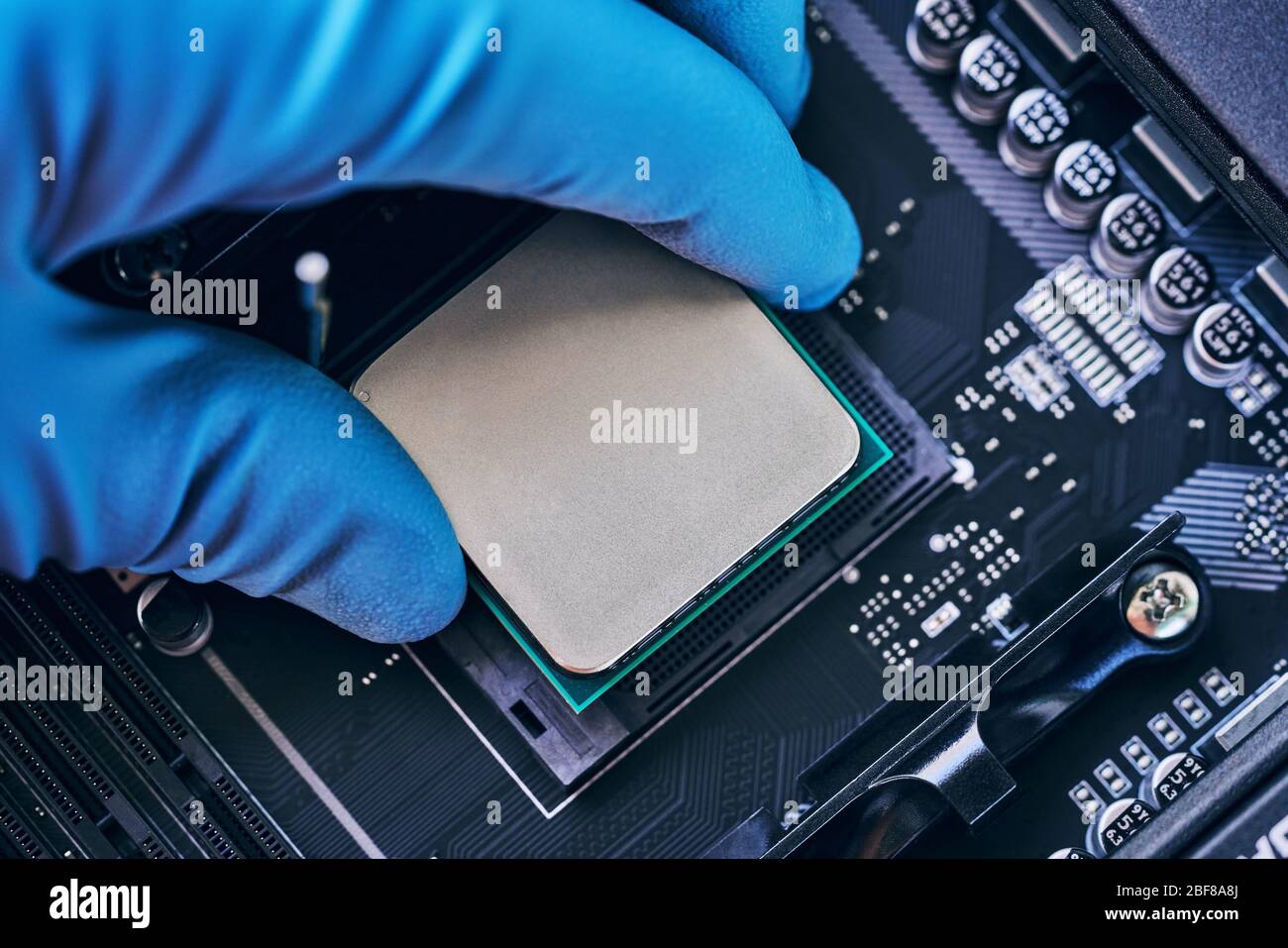 Electronic engineer of computer technology. Installing the processor on the motherboard. Pc repair, technician and industry support concept. Stock Photo