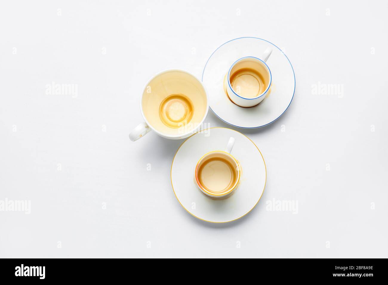 Dirty empty cups with saucers on white background Stock Photo Alamy