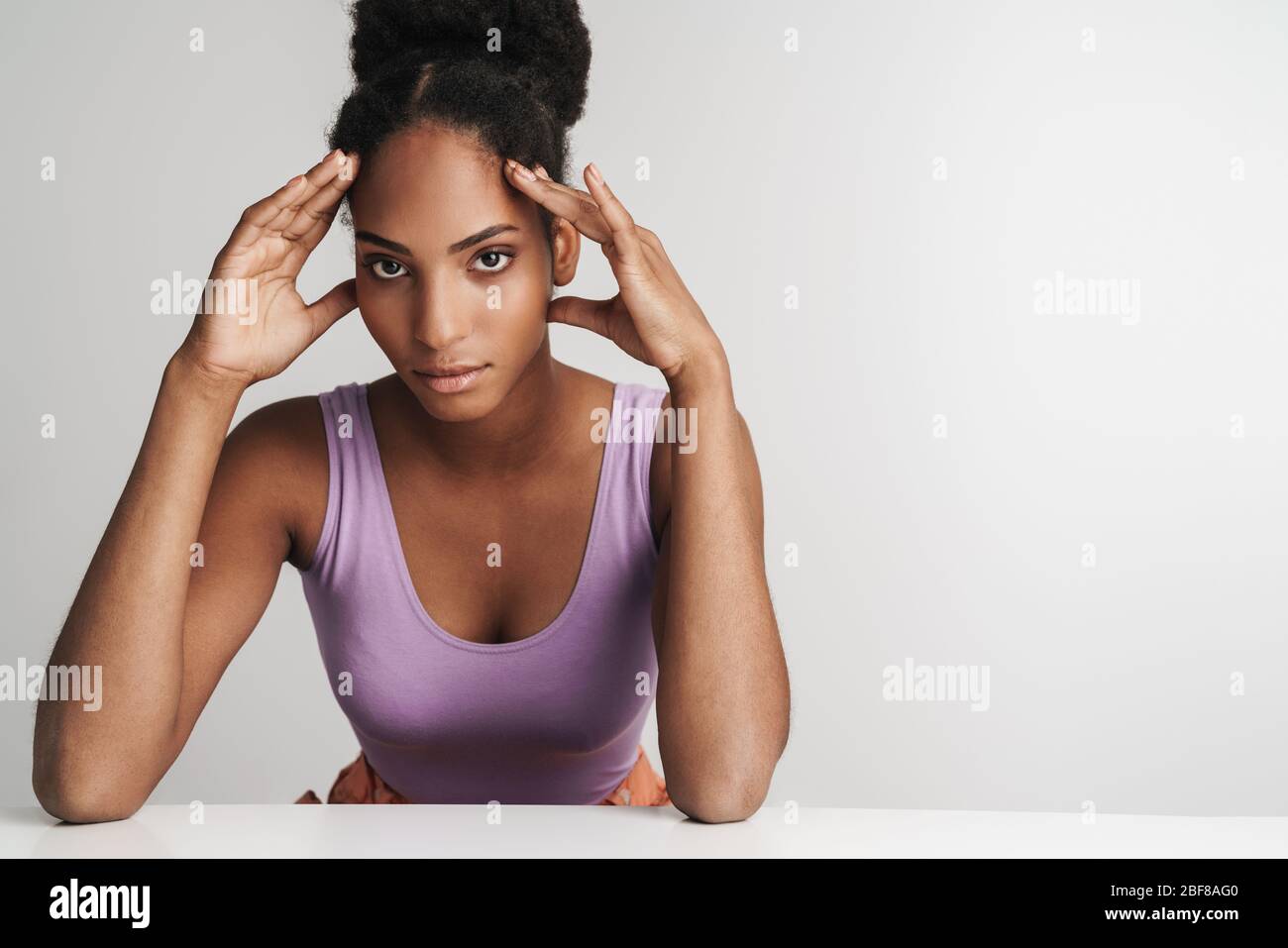 Portrait of african american confident woman looking at camera while ...