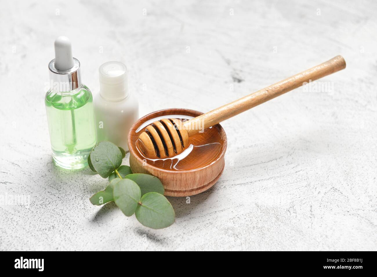 Spa items and honey on light background Stock Photo