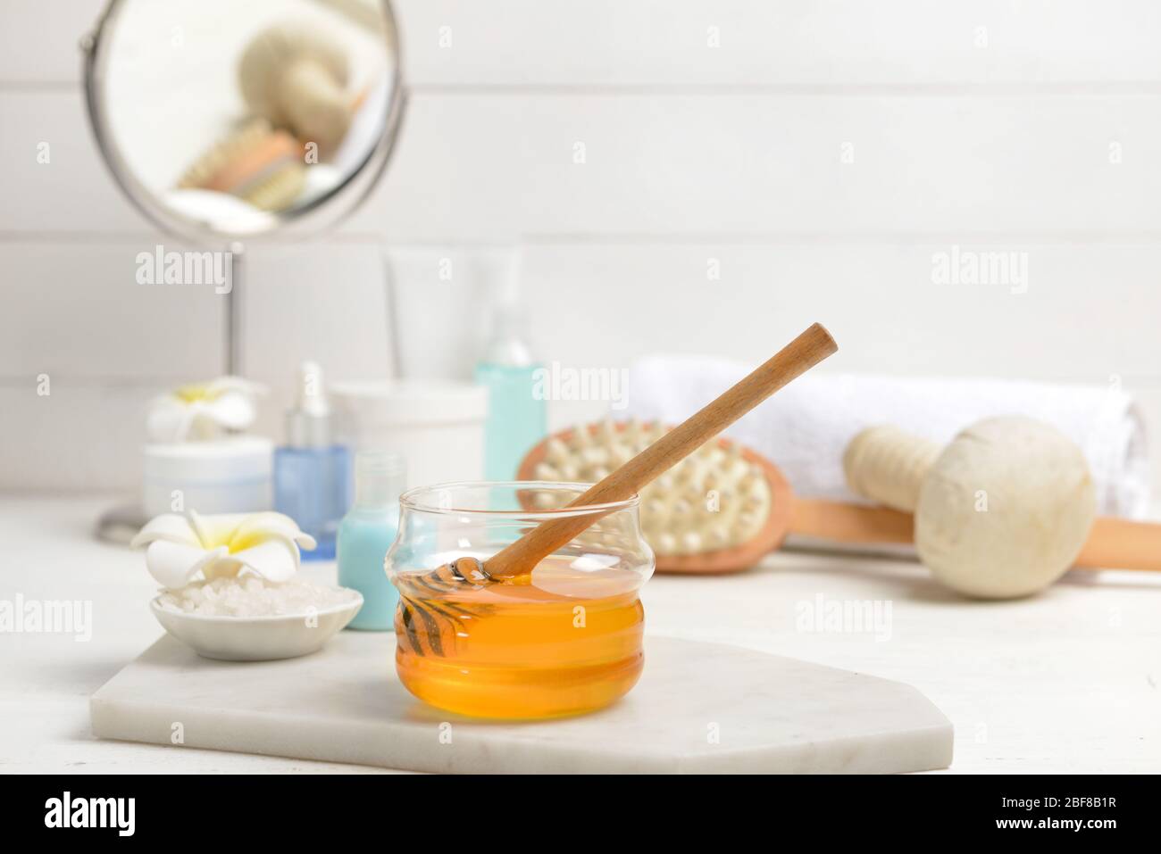 Jar with honey and spa items on table Stock Photo