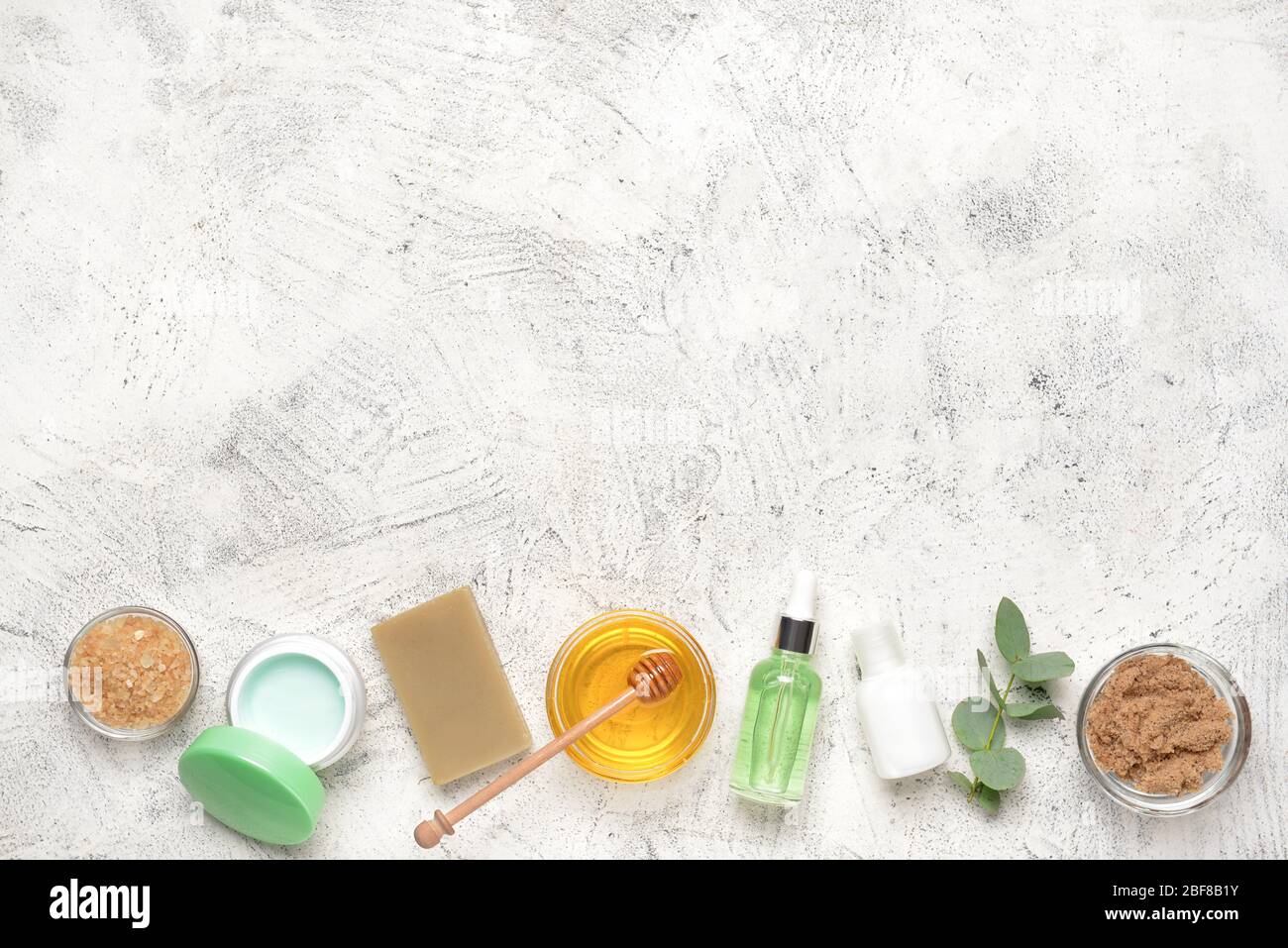 Composition with spa items and honey on light background Stock Photo