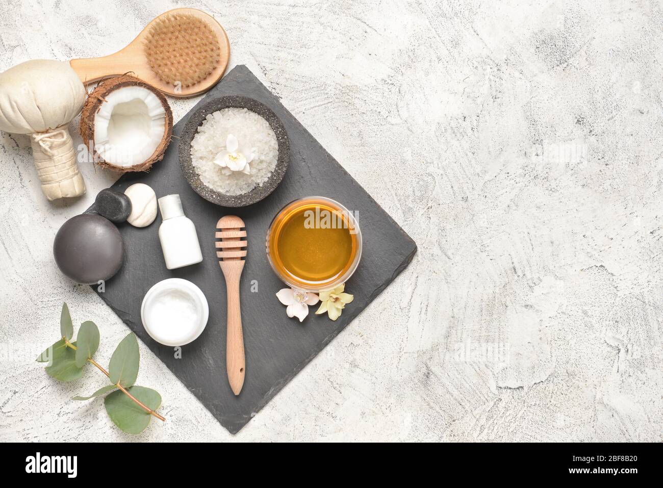 Composition with spa items and honey on light background Stock Photo