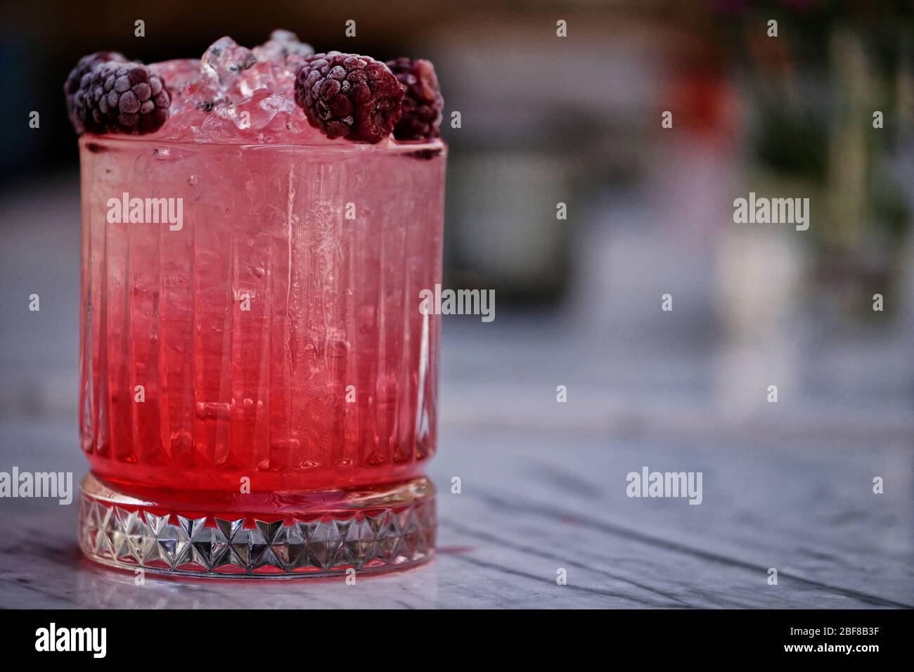 Red and Pink Fresh Colorful Exotic Alcoholic Cocktail with Blackberry on the Wooden Table. Red and Pink Mojito Stock Photo