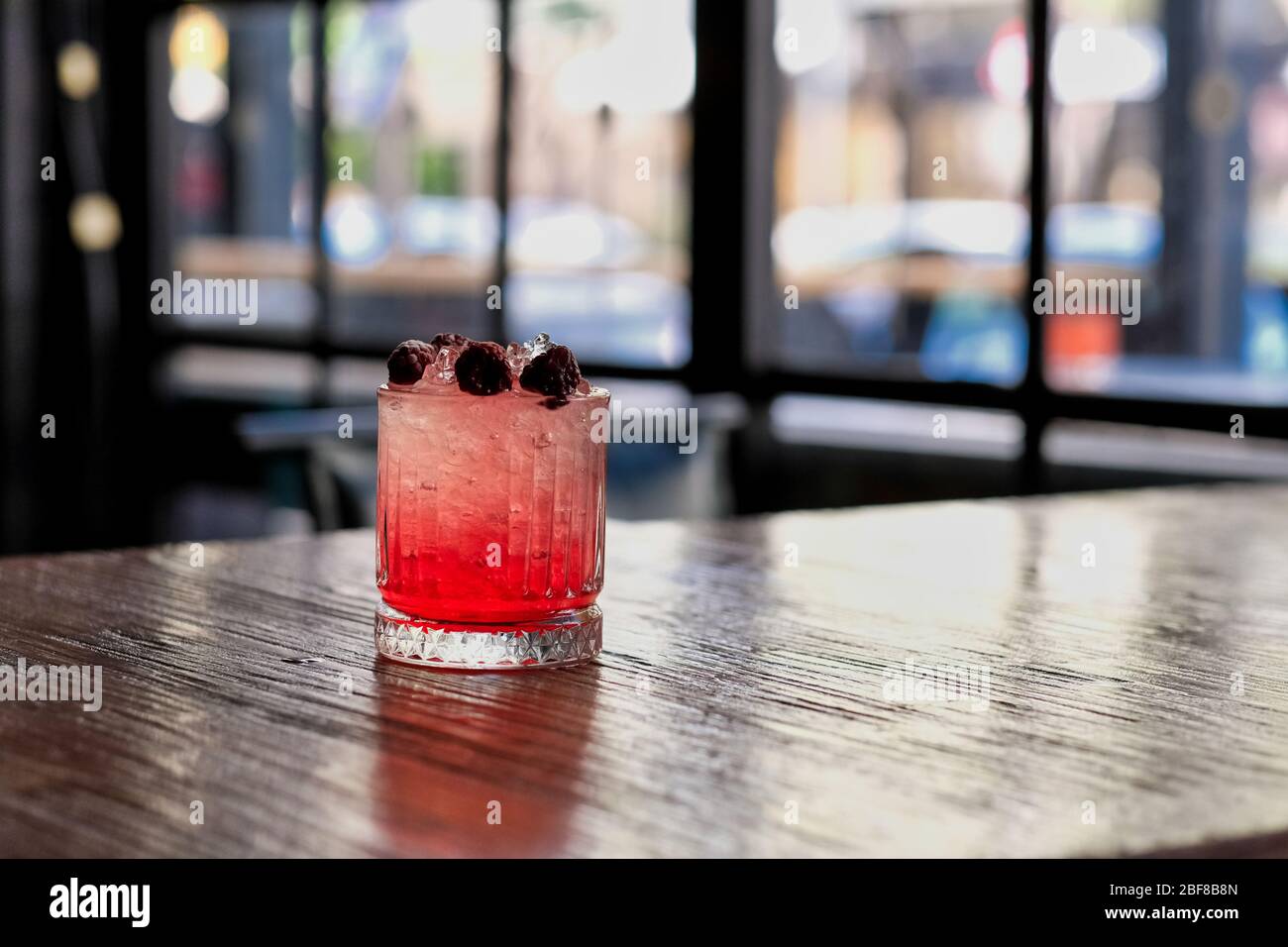 Red and Pink Fresh Colorful Exotic Alcoholic Cocktail with Blackberry on the Wooden Table. Red and Pink Mojito Stock Photo