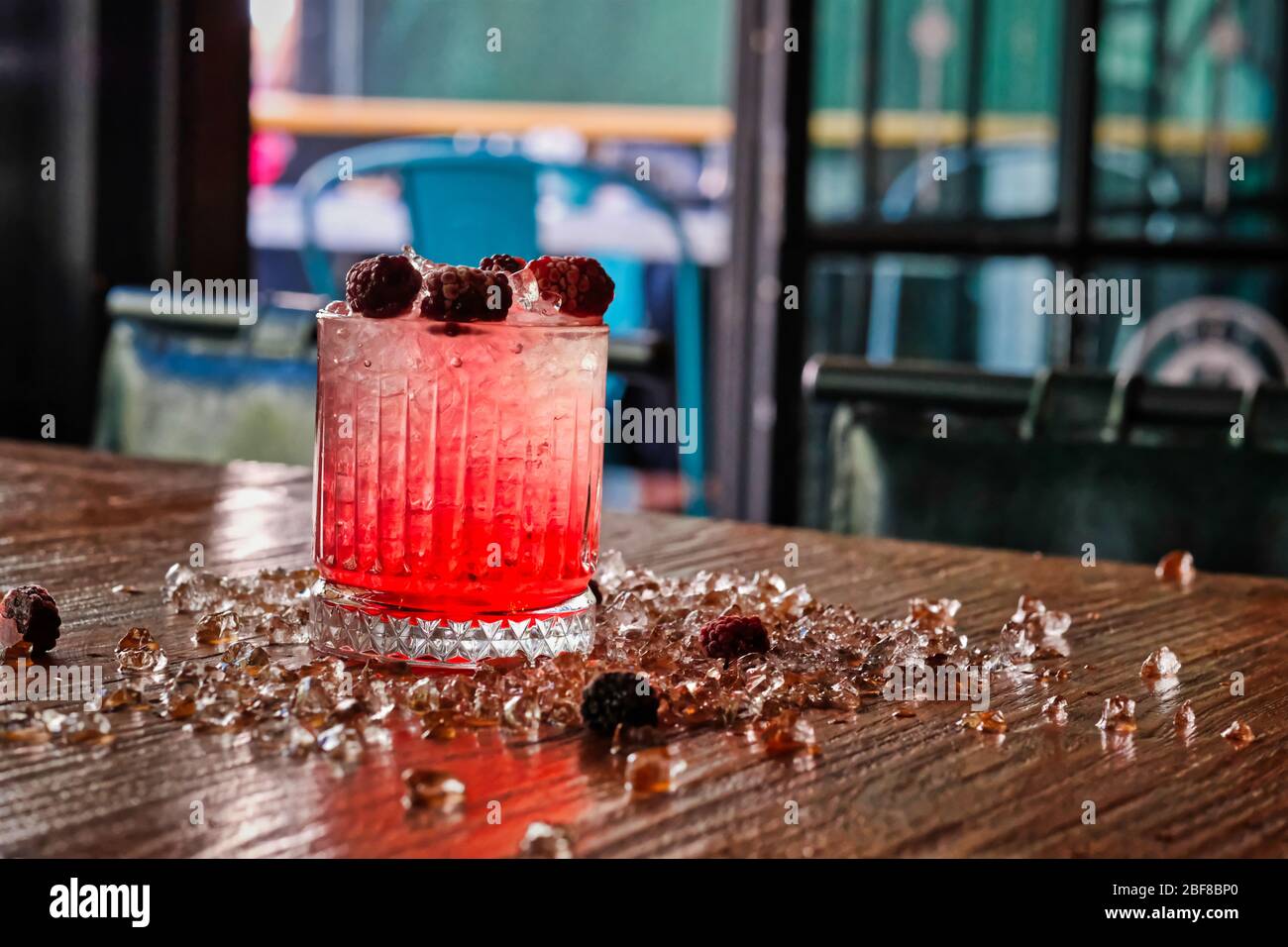 Red and Pink Fresh Colorful Exotic Alcoholic Cocktail with Blackberry on the Wooden Table. Red and Pink Mojito Stock Photo