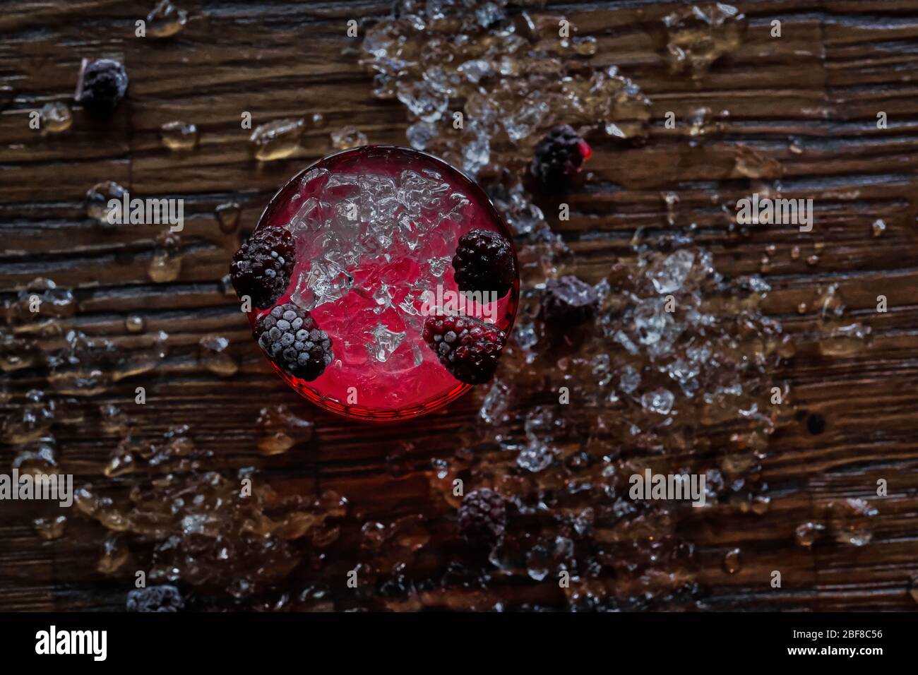 Red and Pink Fresh Colorful Exotic Alcoholic Cocktail with Blackberry on the Wooden Table. Red and Pink Mojito Stock Photo