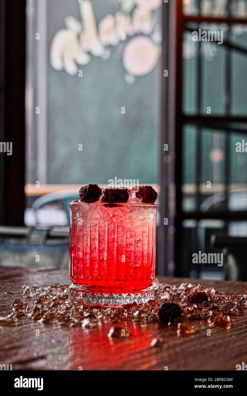 Red and Pink Fresh Colorful Exotic Alcoholic Cocktail with Blackberry on the Wooden Table. Red and Pink Mojito Stock Photo