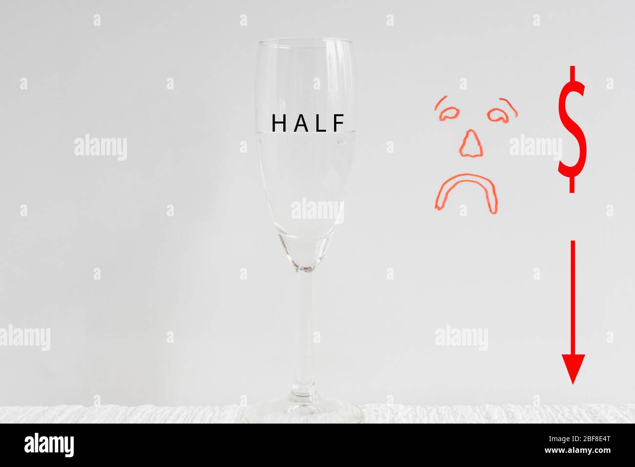 One wine glass, half full with drawn sad face in background depicting