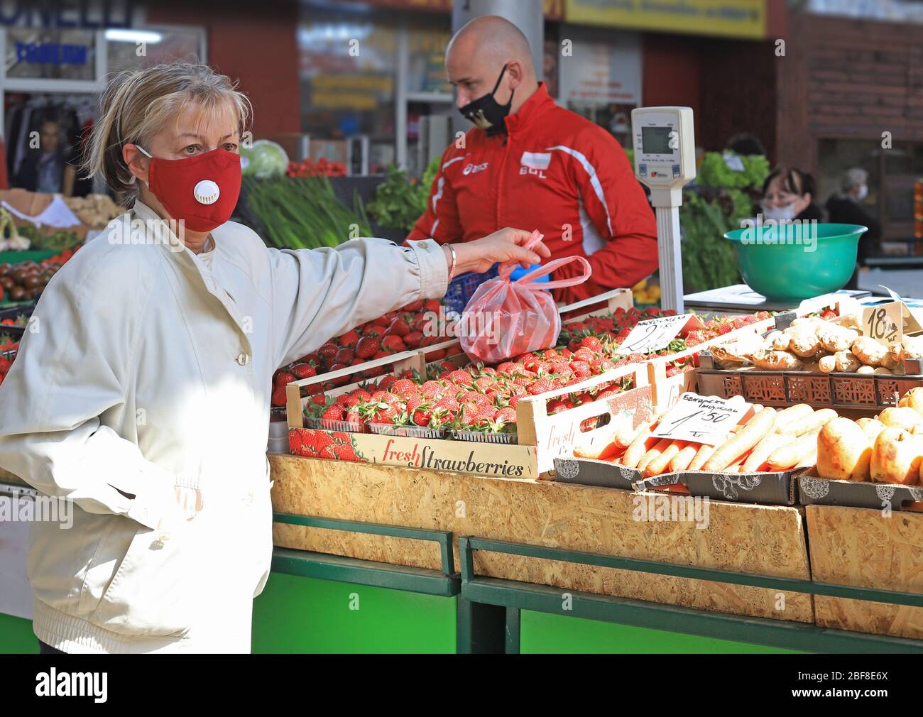 People wearing face masks and gloves for prevention of coronavirus COVID-19 on a marketplace in Sofia, Bulgaria on 04/14/2020. Stock Photo