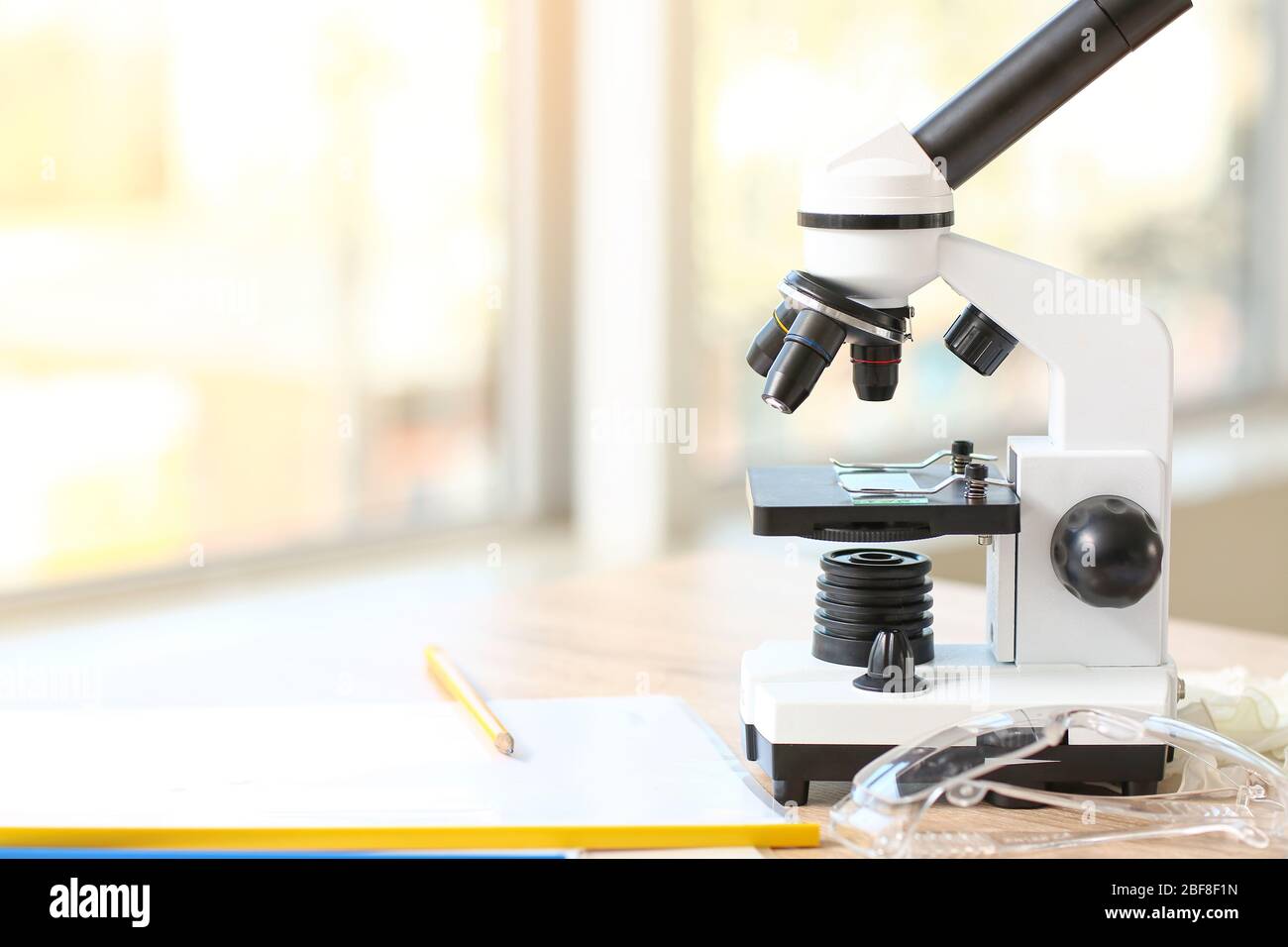 Microscope on table in classroom Stock Photo Alamy