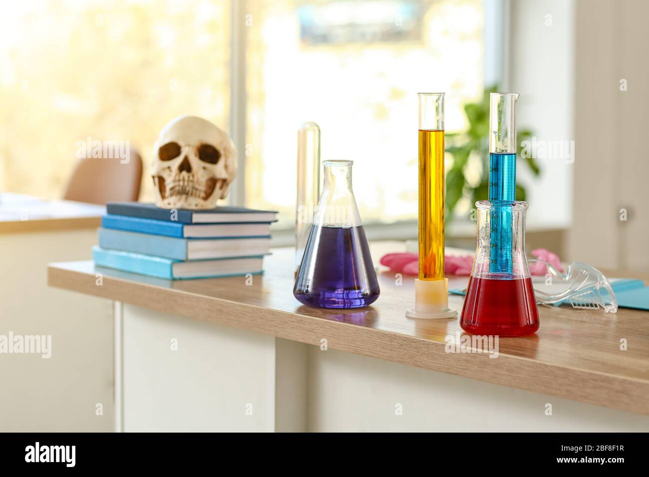 Laboratory glassware with samples on table in classroom Stock Photo - Alamy