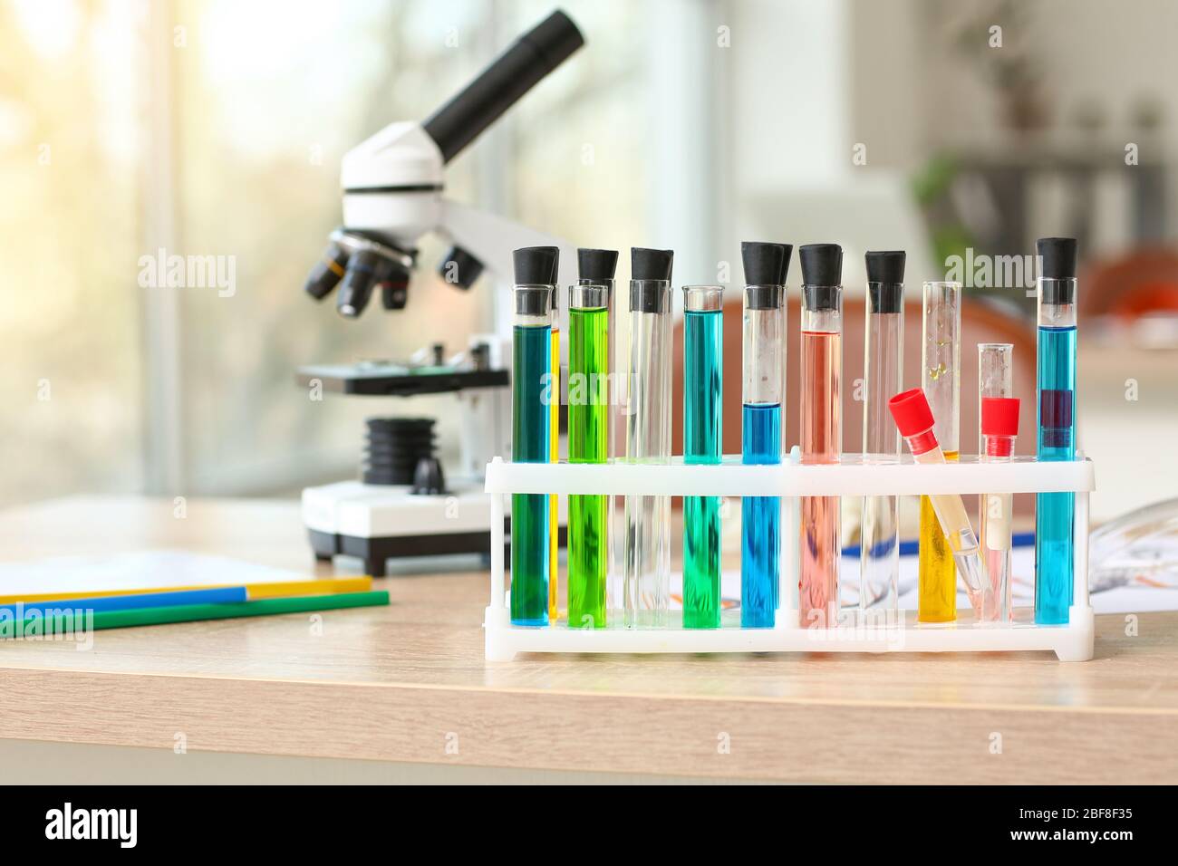 Laboratory glassware with samples on table in classroom Stock Photo - Alamy