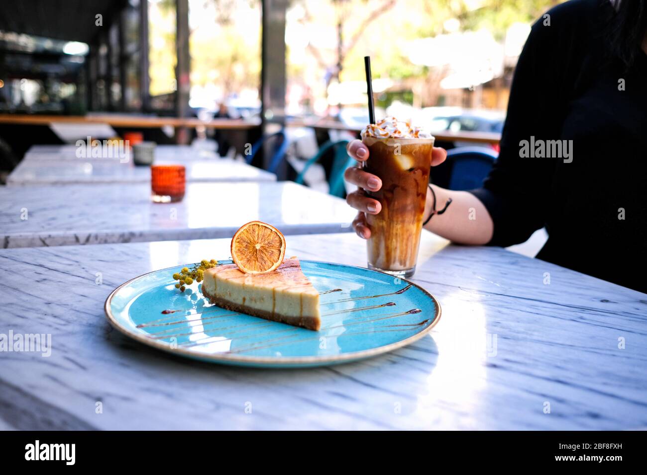 Frappe coffee with lemon cheesecake on marble table Stock Photo