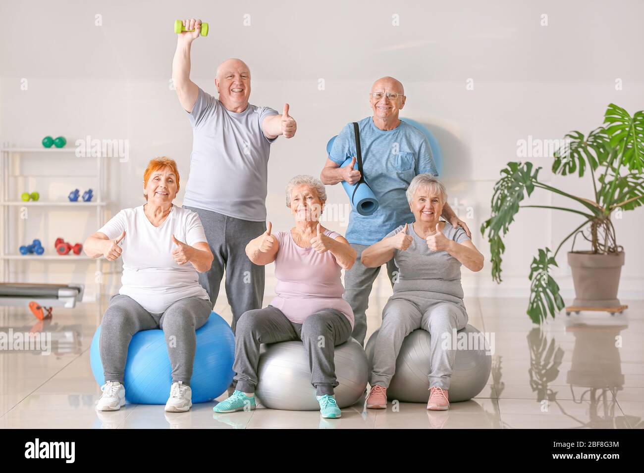 Happy elderly people in gym Stock Photo - Alamy