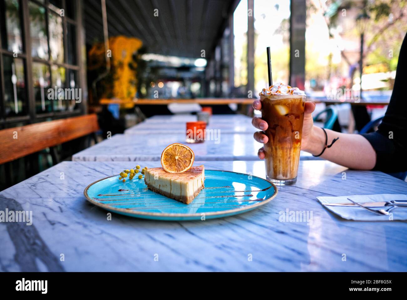 Frappe coffee with lemon cheesecake on marble table Stock Photo