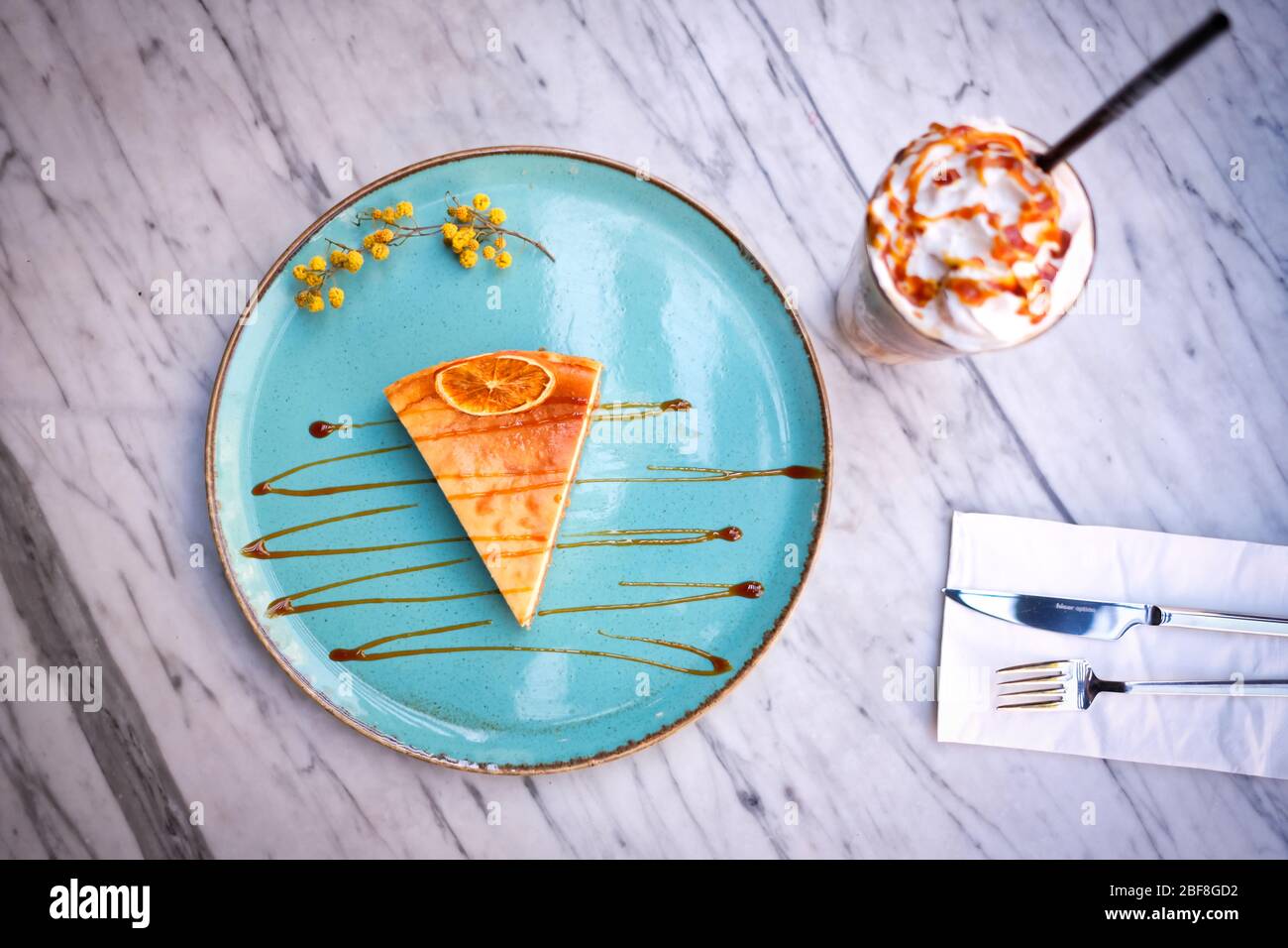 Frappe coffee with lemon cheesecake on marble table Stock Photo