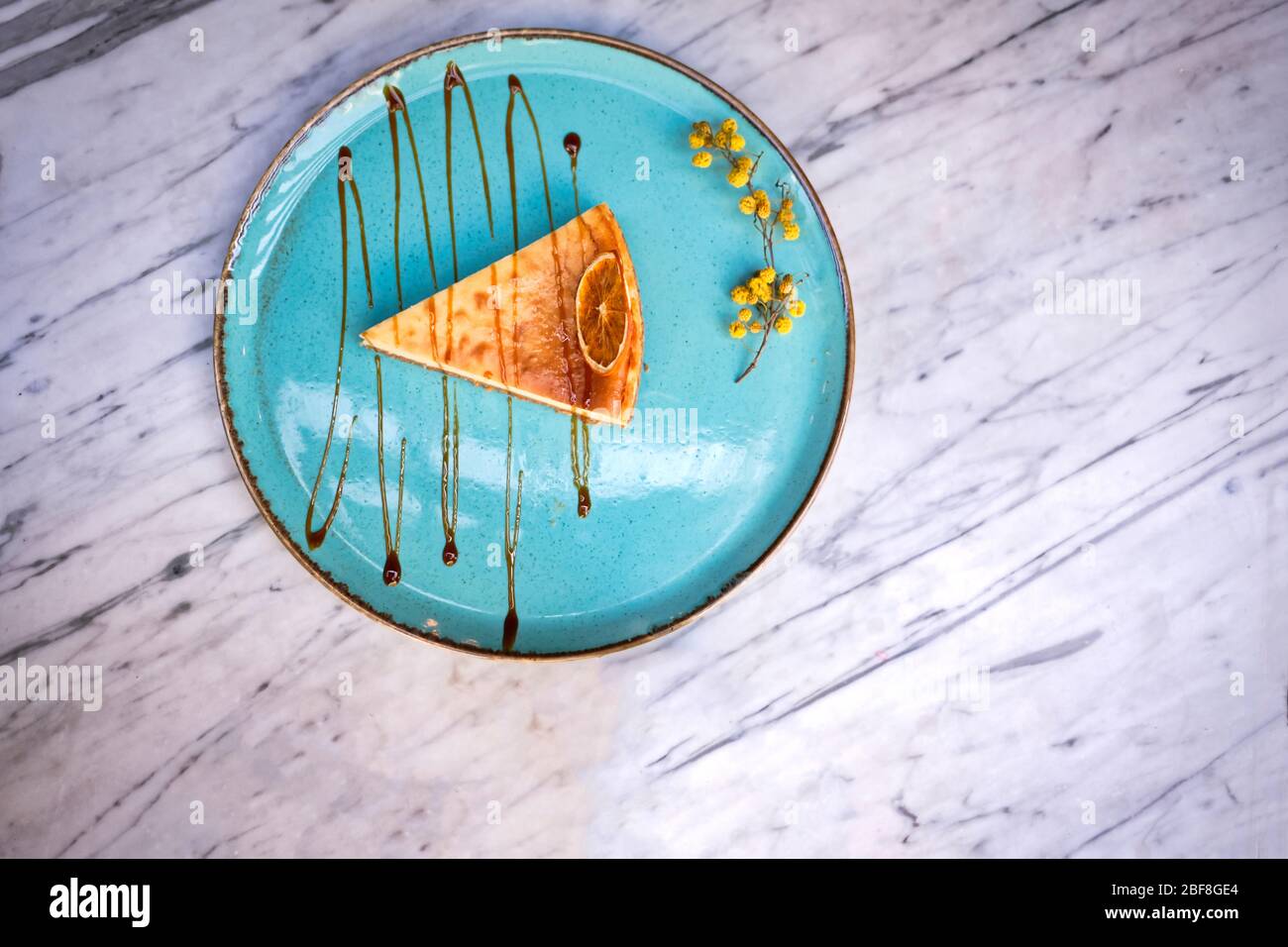 Frappe coffee with lemon cheesecake on marble table Stock Photo