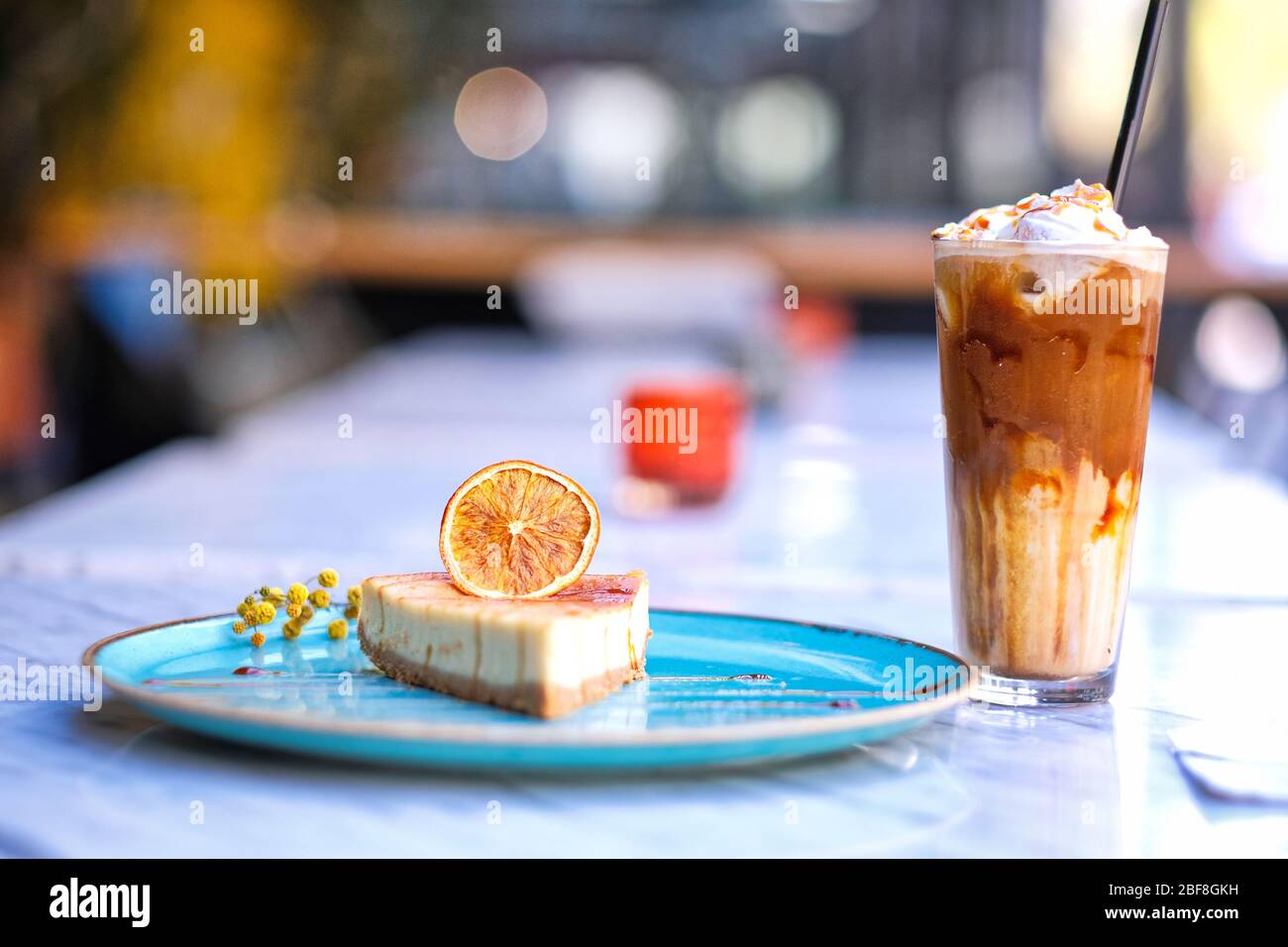 Frappe coffee with lemon cheesecake on marble table Stock Photo