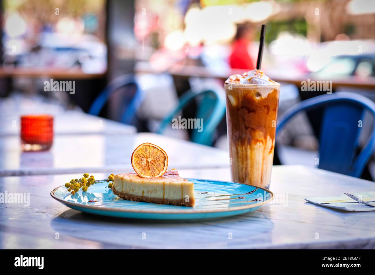 Frappe coffee with lemon cheesecake on marble table Stock Photo