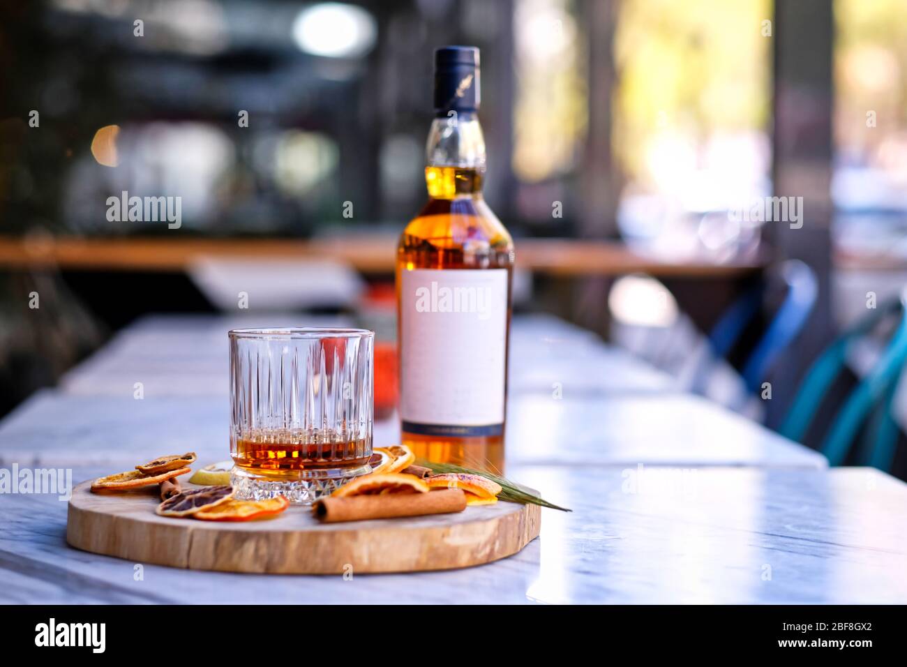 A bottle of whiskey. Drink a glass of whiskey alcohol on the presentation board Stock Photo
