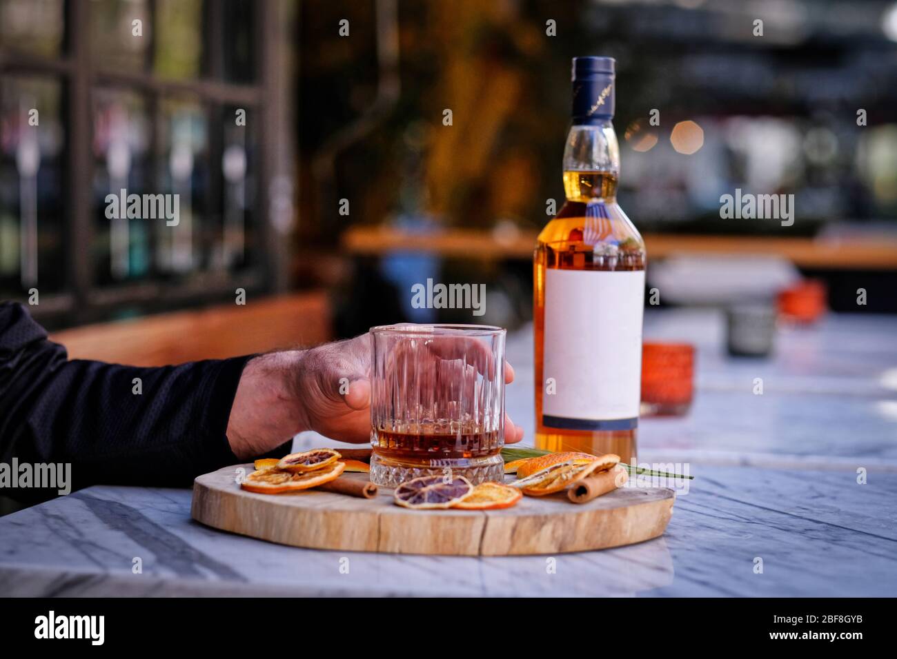 A bottle of whiskey. Drink a glass of whiskey alcohol on the presentation board Stock Photo