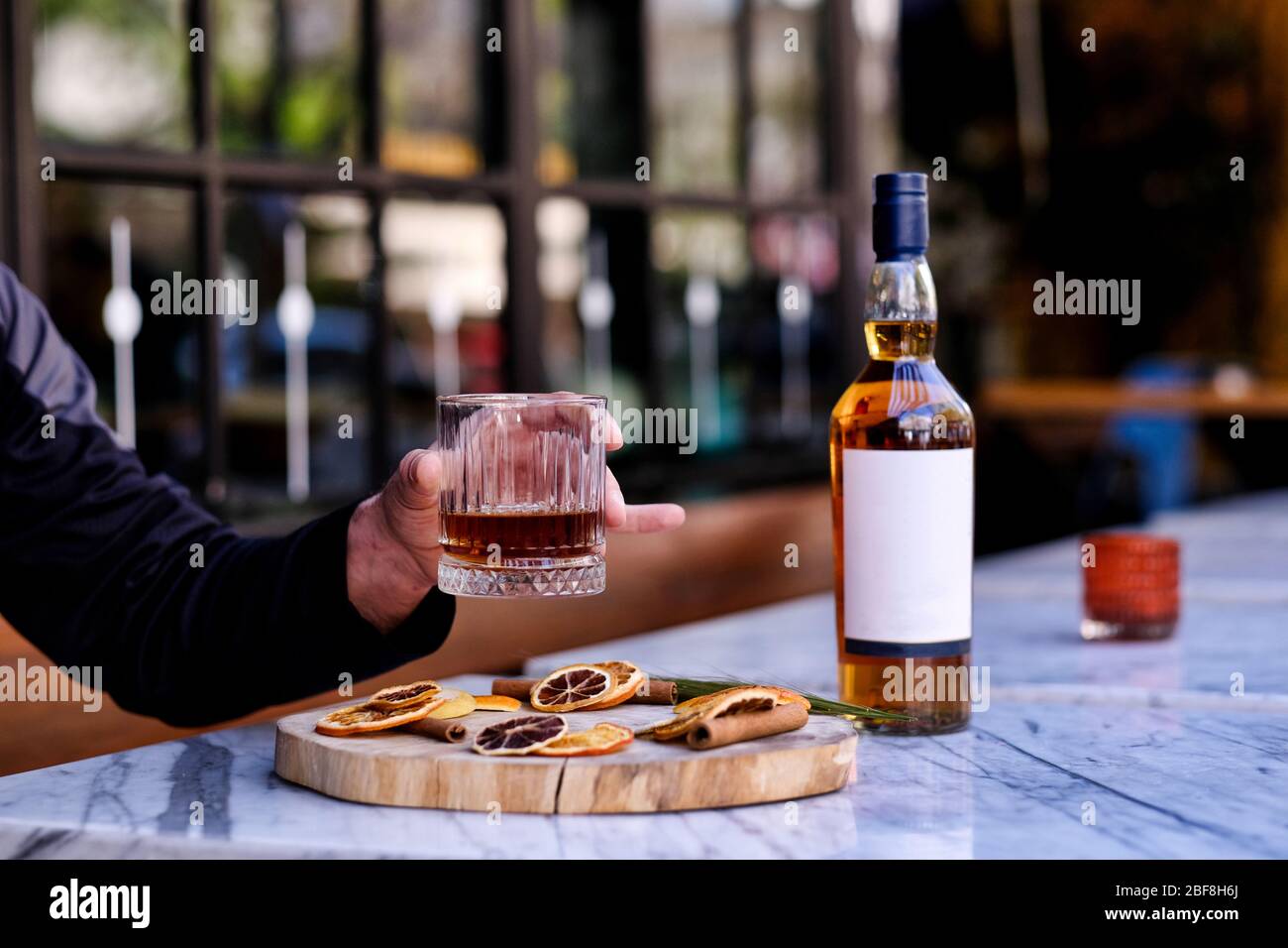 A bottle of whiskey. Drink a glass of whiskey alcohol on the presentation board Stock Photo