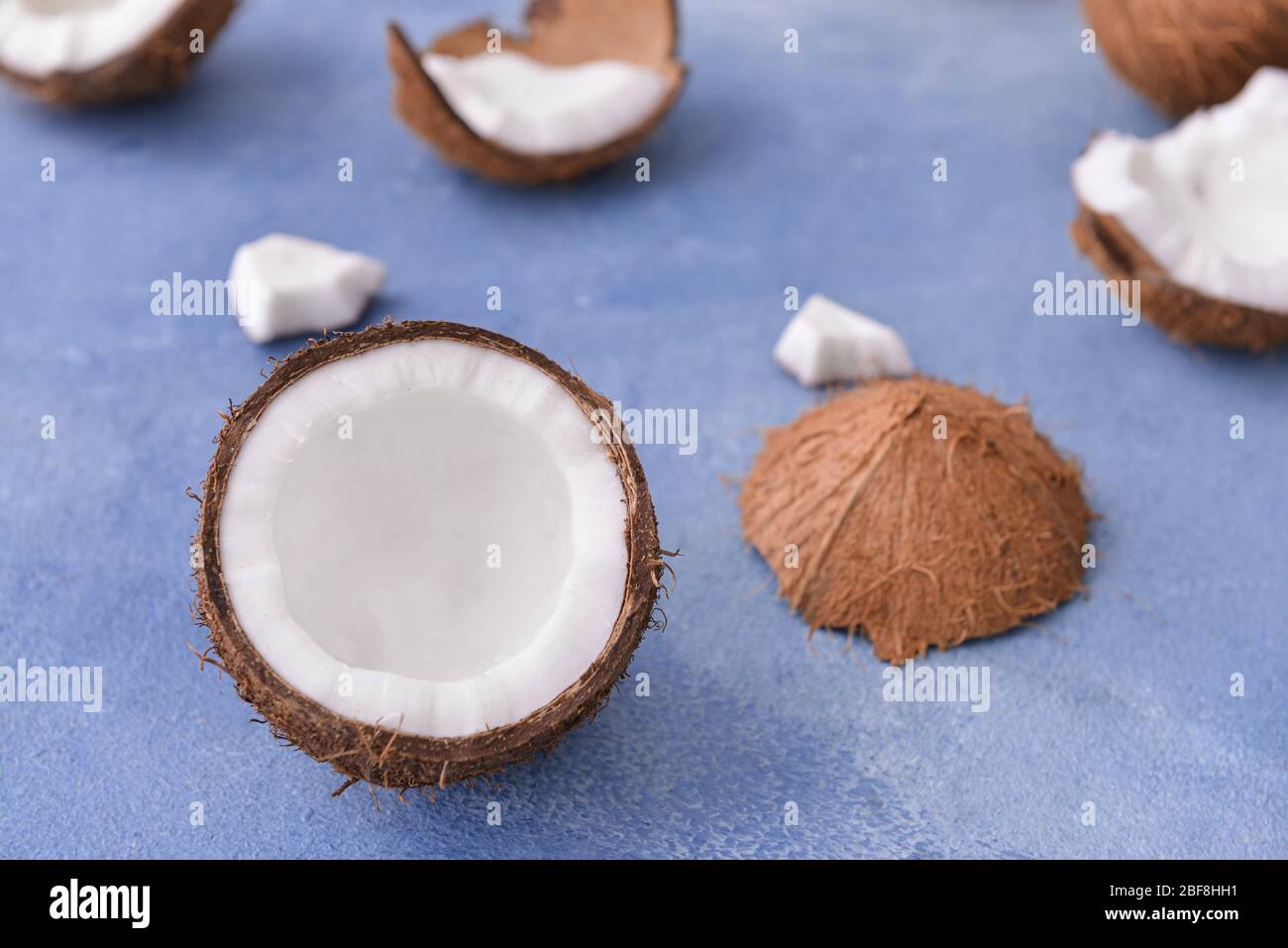 Ripe coconuts on color background Stock Photo