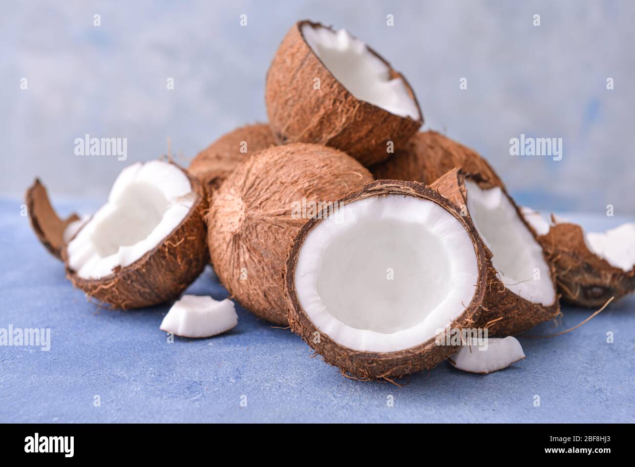 Ripe coconuts on color background Stock Photo
