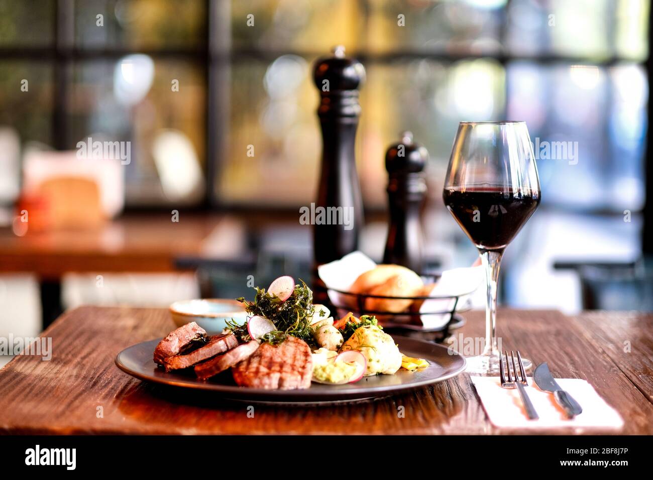 Specially crafted beef steak accompanied by red wine Stock Photo