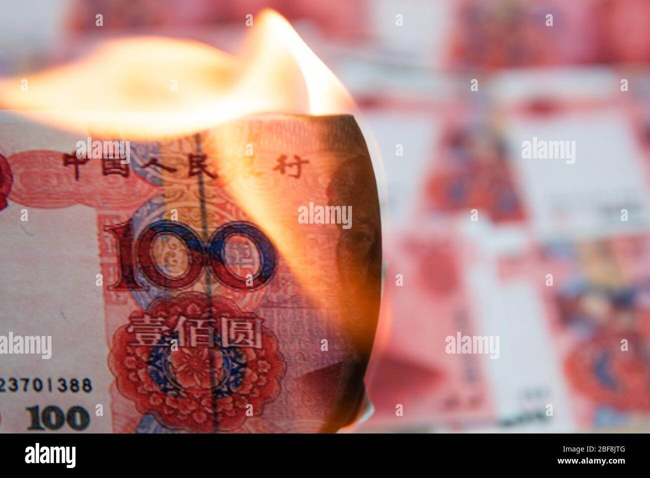 Burning Chinese yuan as symbol economic recession. Stock Photo