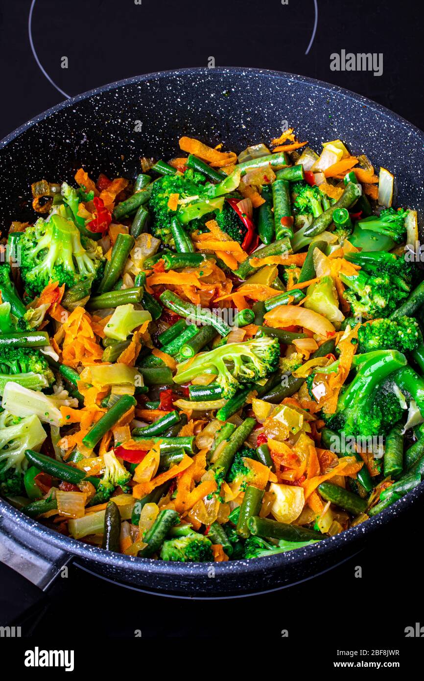 Stewed vegetables in a pan. Cooking process. Vegan food. Broccoli
