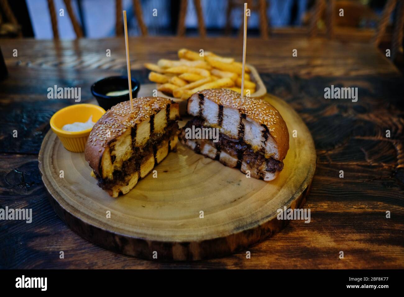 Fast Food, Hamburger. Special veal prepared hamburger, french fries and double cheddar cheese. Close-up fresh delicious tasty homemade burger. Stock Photo