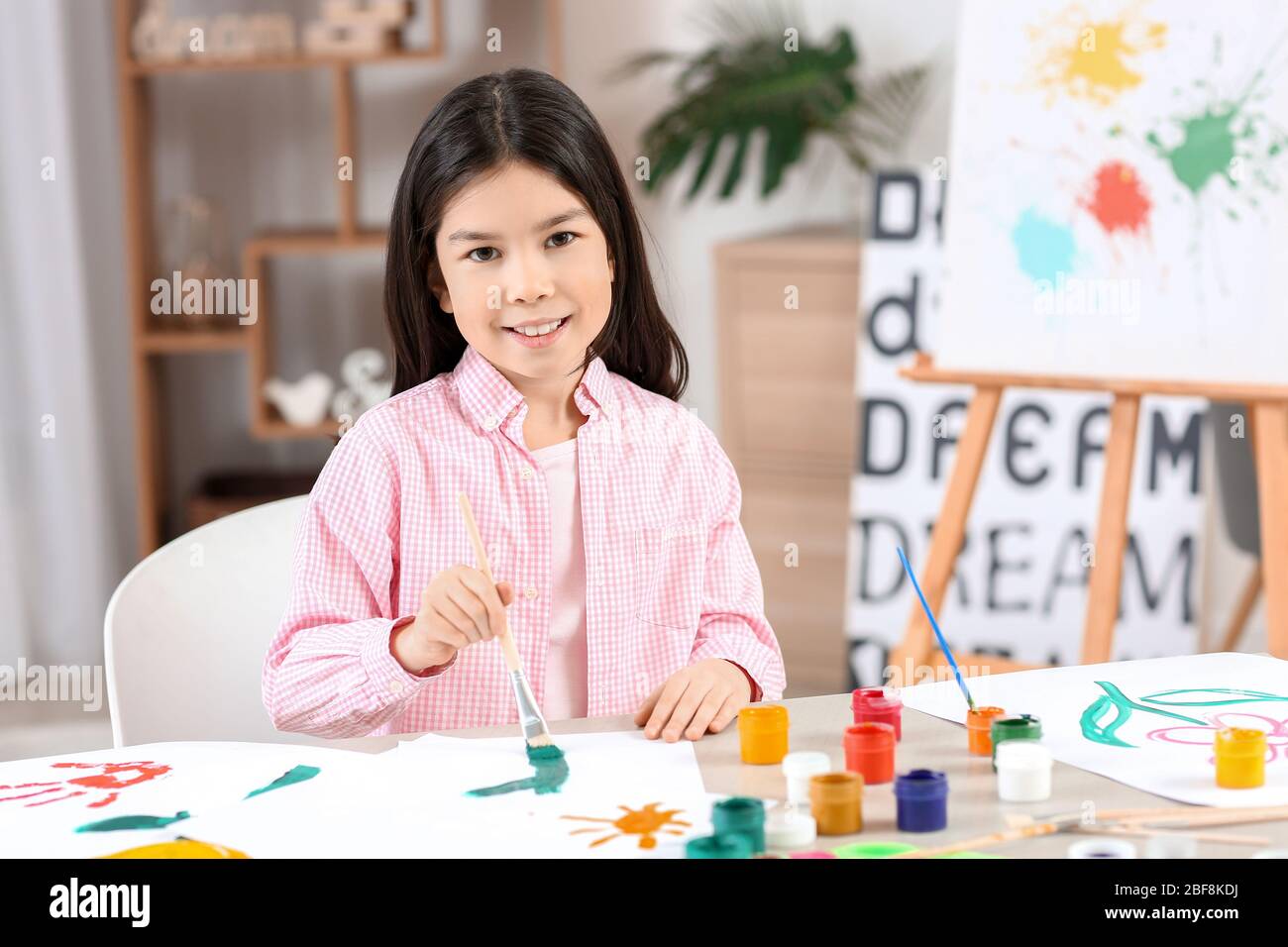 Cute little girl painting at home Stock Photo - Alamy