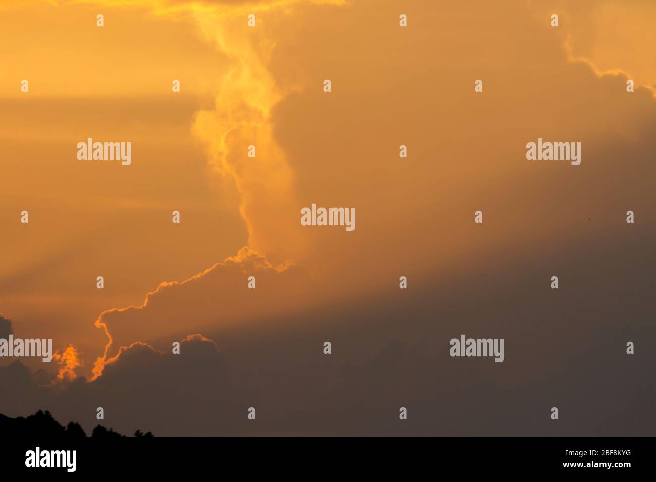 sunset orange and yellow cumulus clouds in a summer day Stock Photo