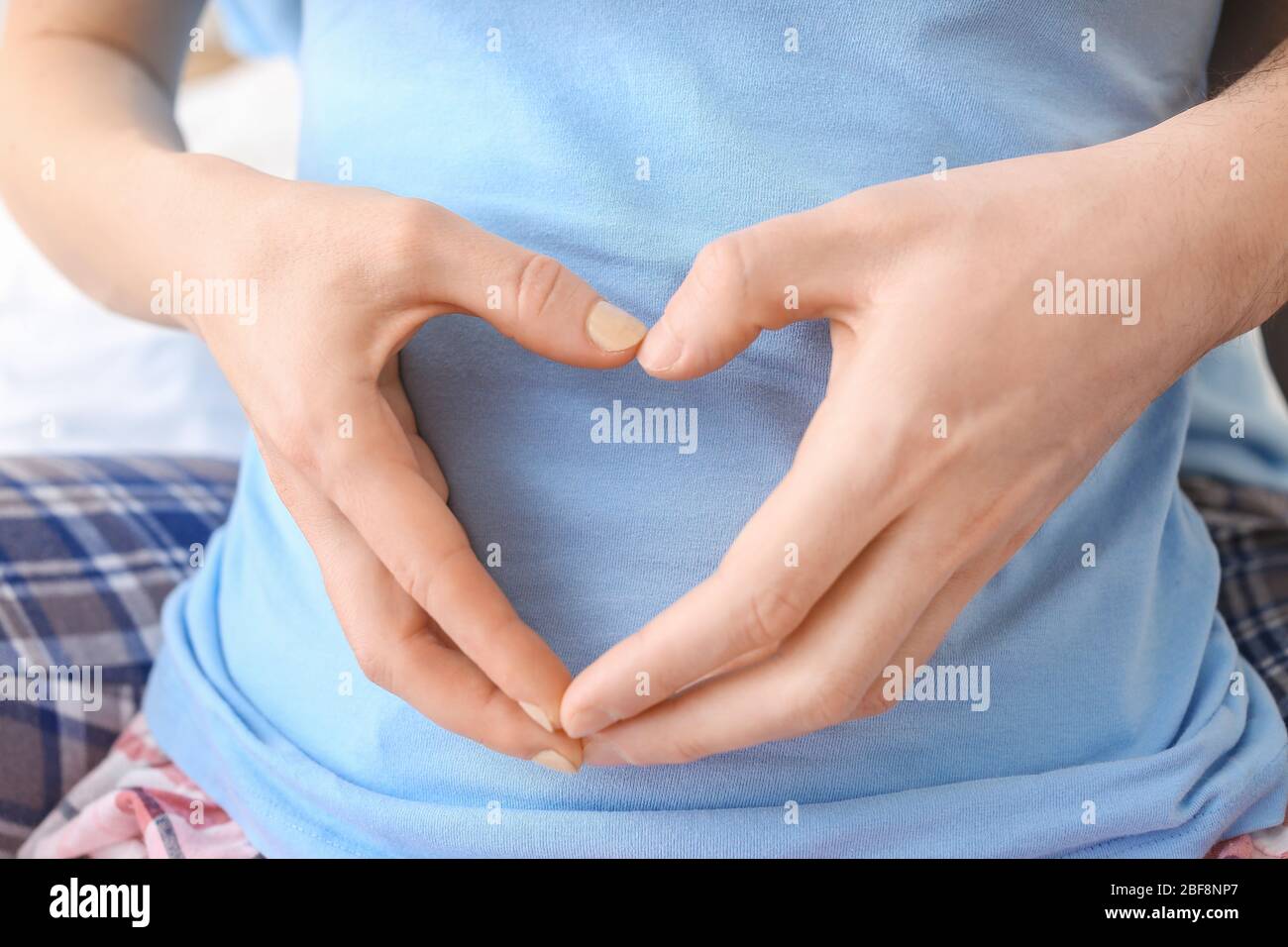 Young couple making heart shape with their hands, closeup Stock Photo ...