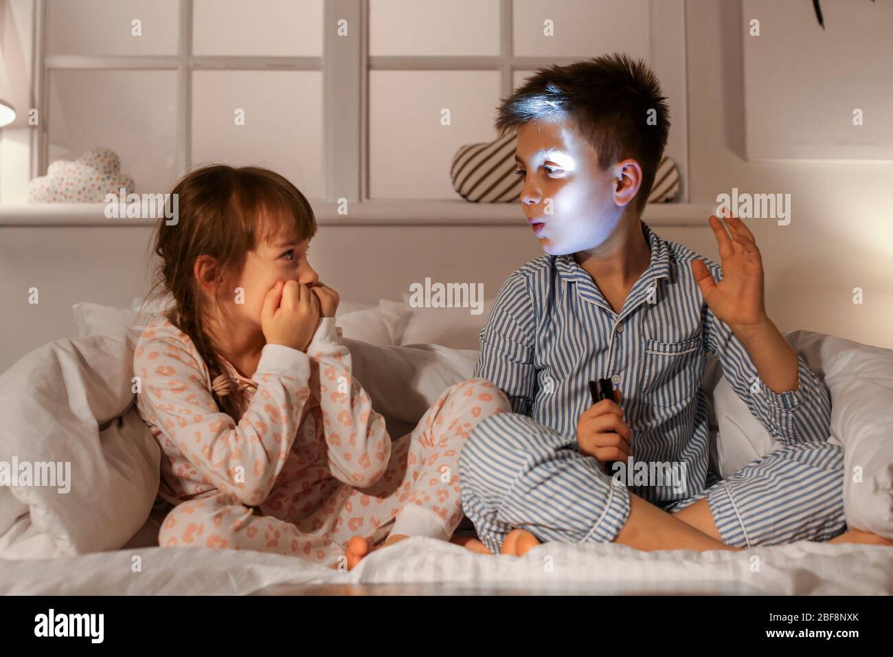 Emotional little children in bedroom at home Stock Photo