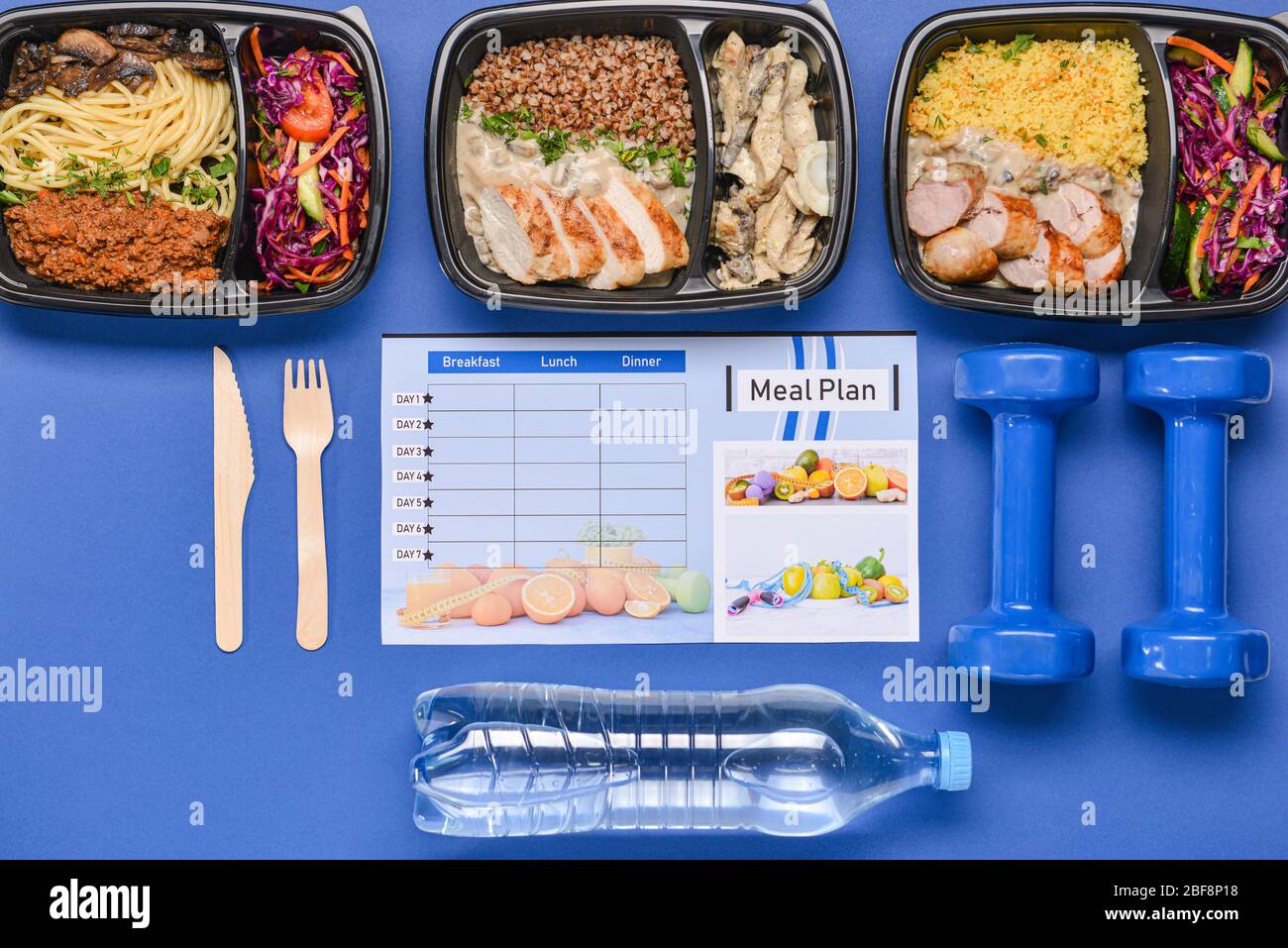 Food Container Plan Containers with healthy food, bottle of water, dumbbells and meal plan ...