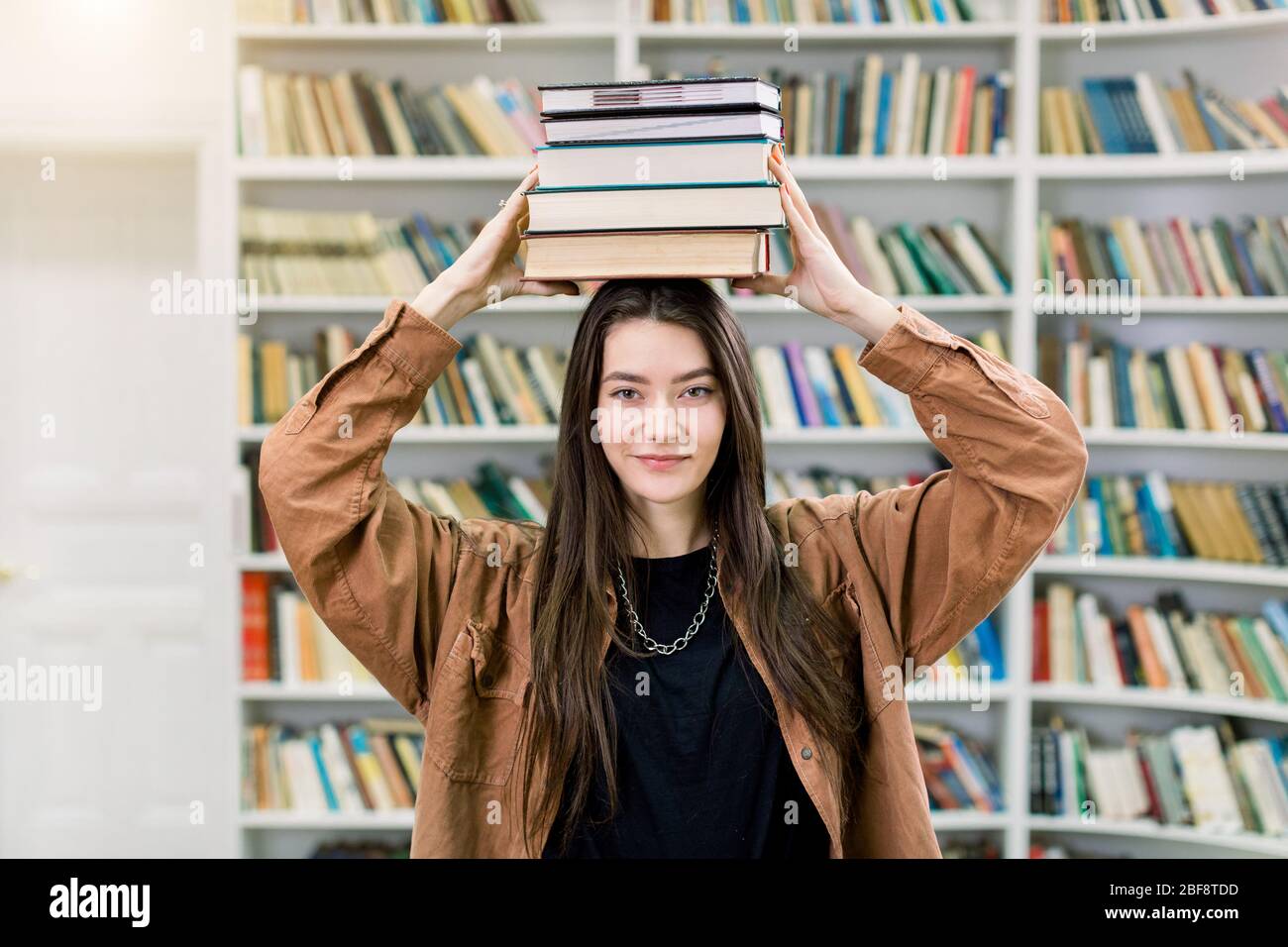 Woman balancing books head hires stock photography and images Alamy