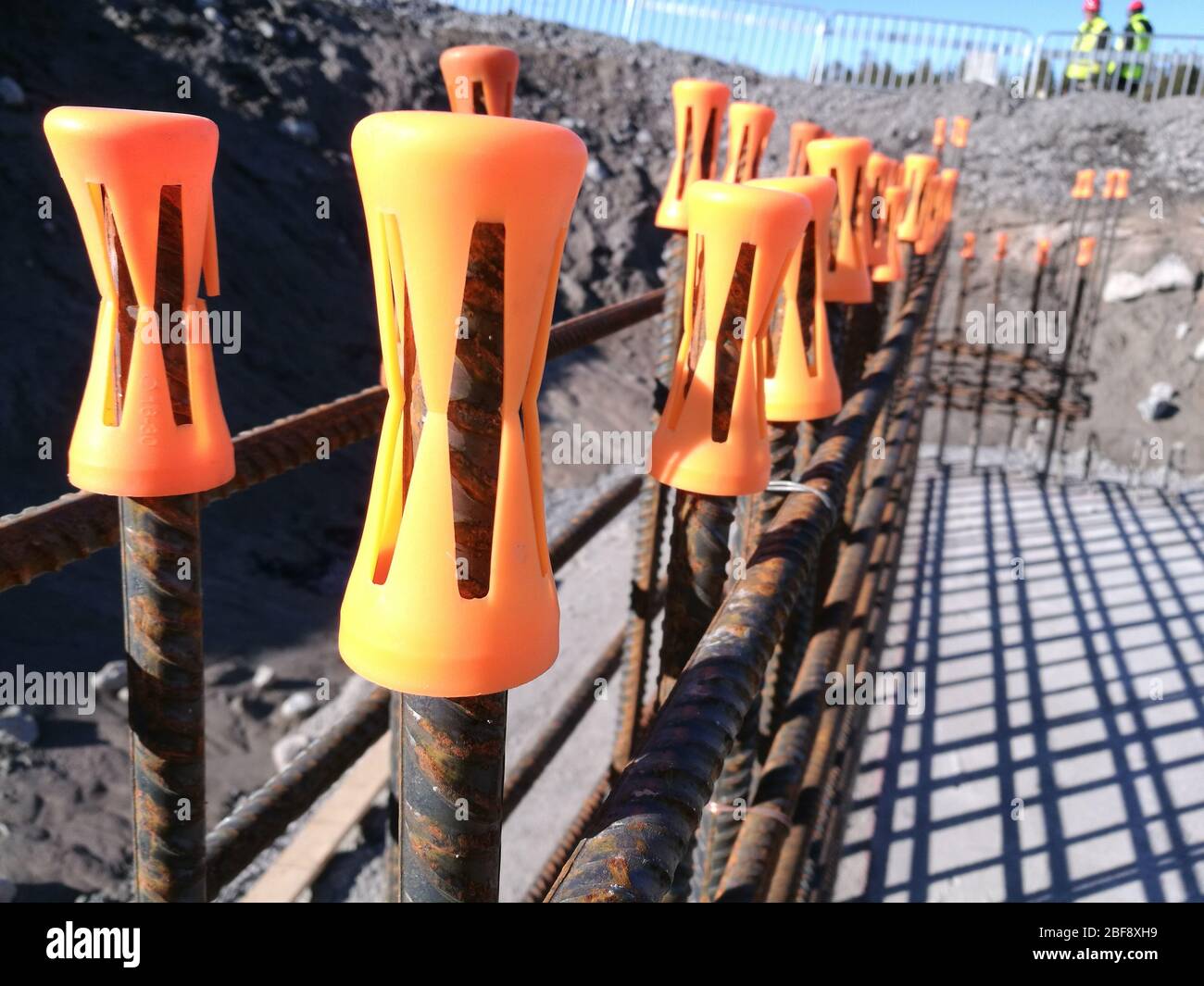 Concrete rebar with safety caps. Stock Photo