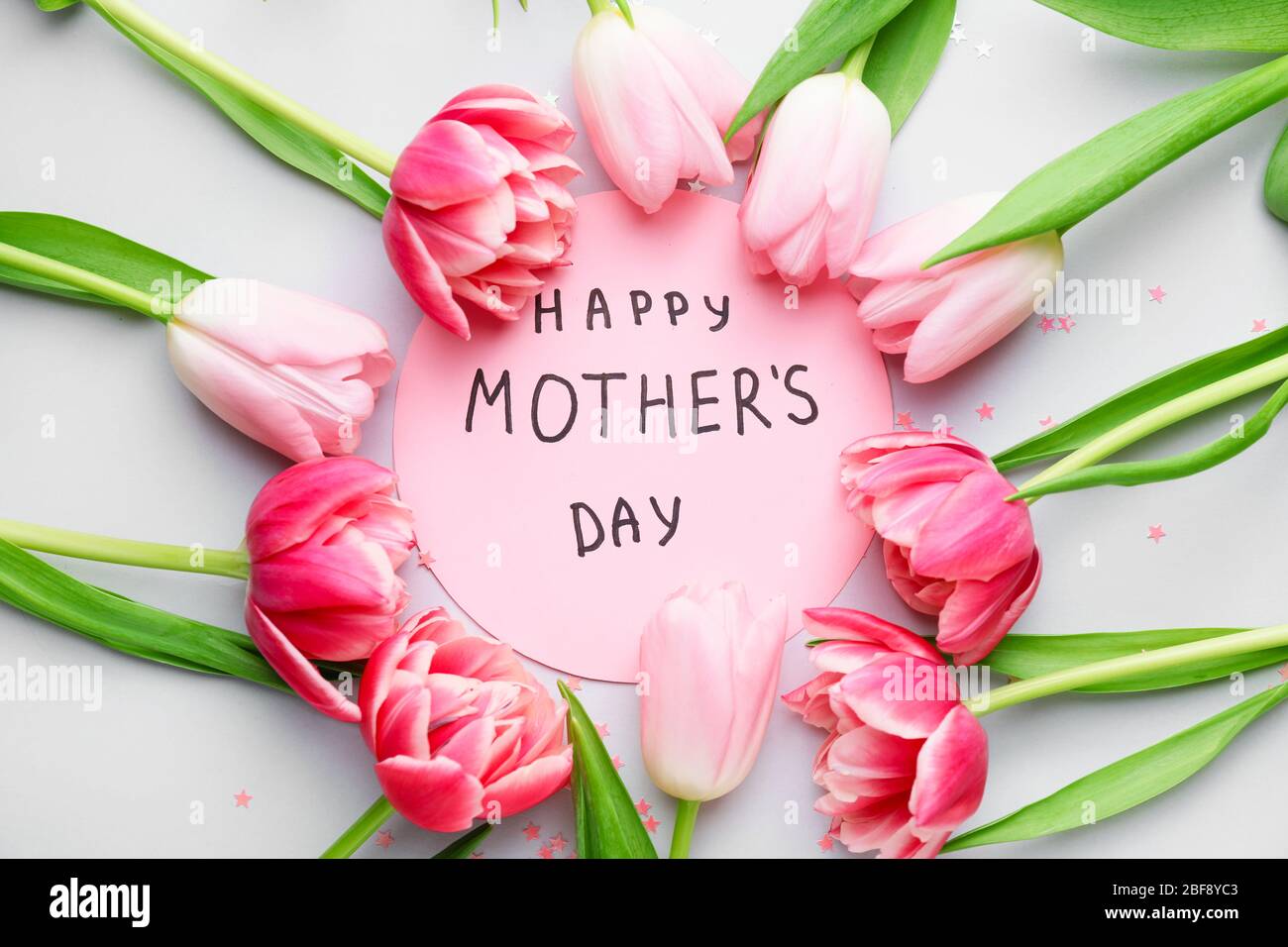 Beautiful flowers and card for Mother's Day on white background Stock ...