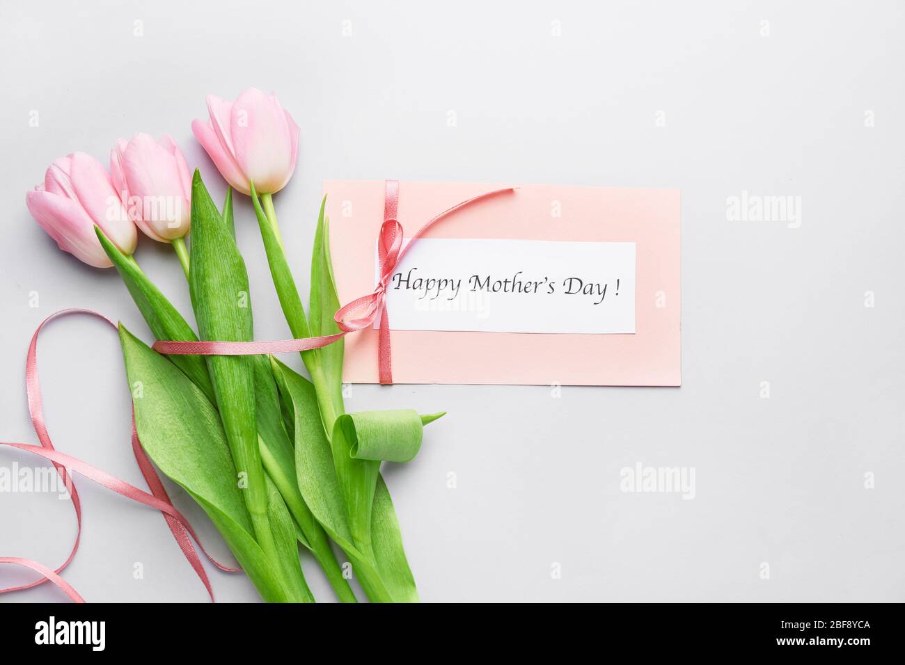 Beautiful flowers and card for Mother's Day on white background Stock ...