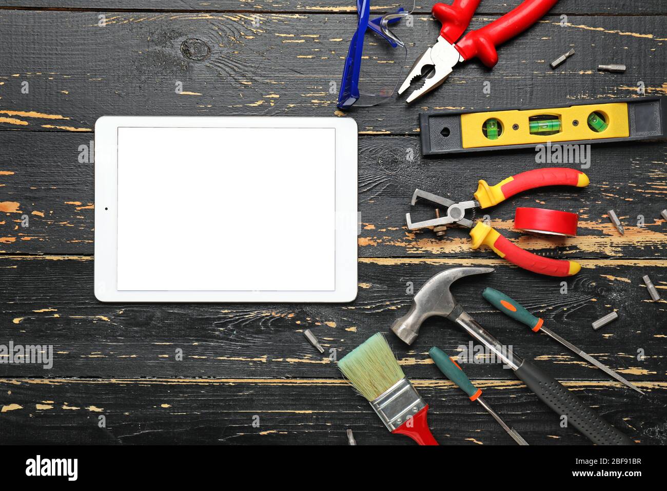 Builder's tools with tablet computer on wooden background Stock Photo