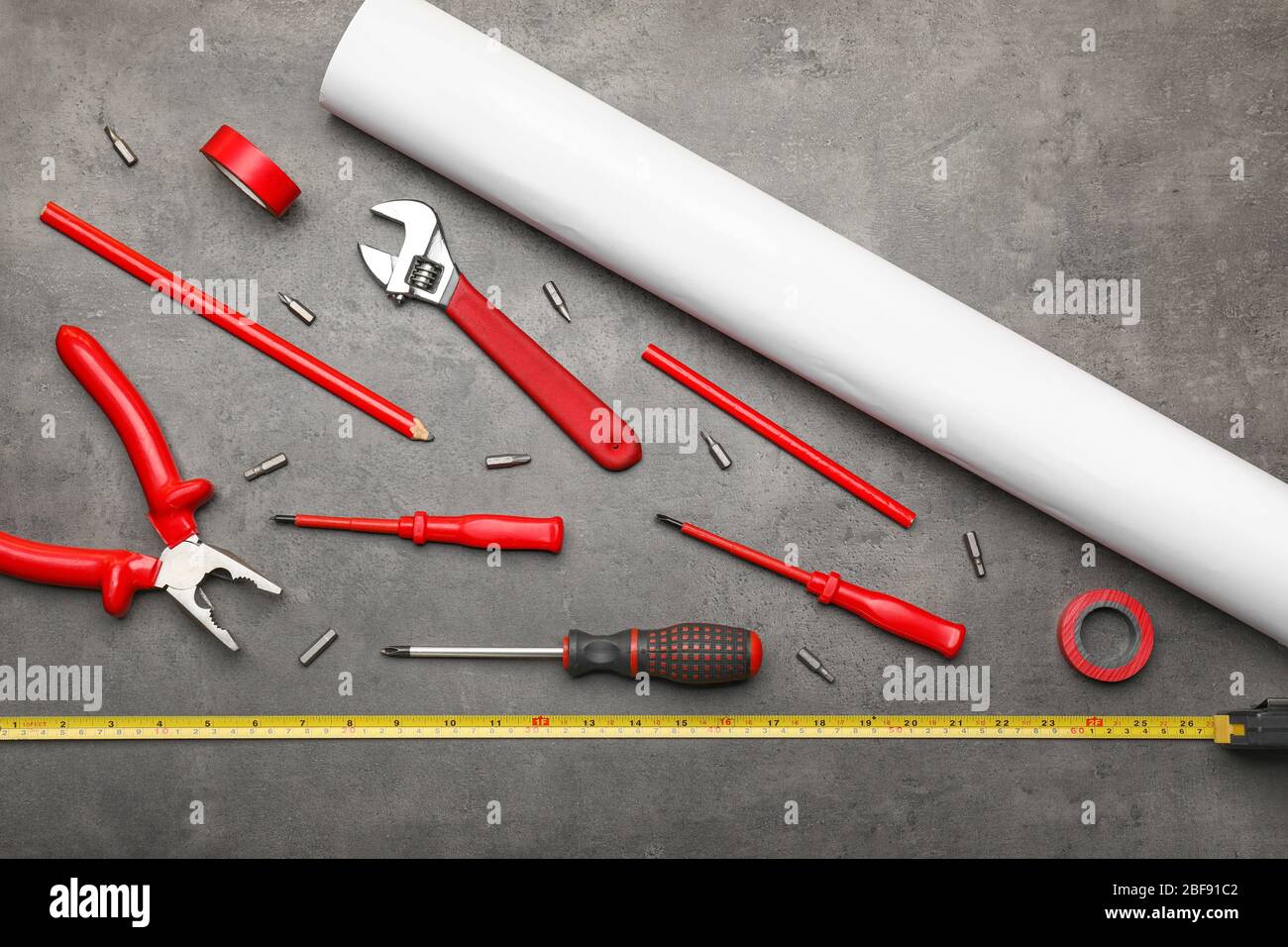 Builder's tools and blueprint on dark background Stock Photo